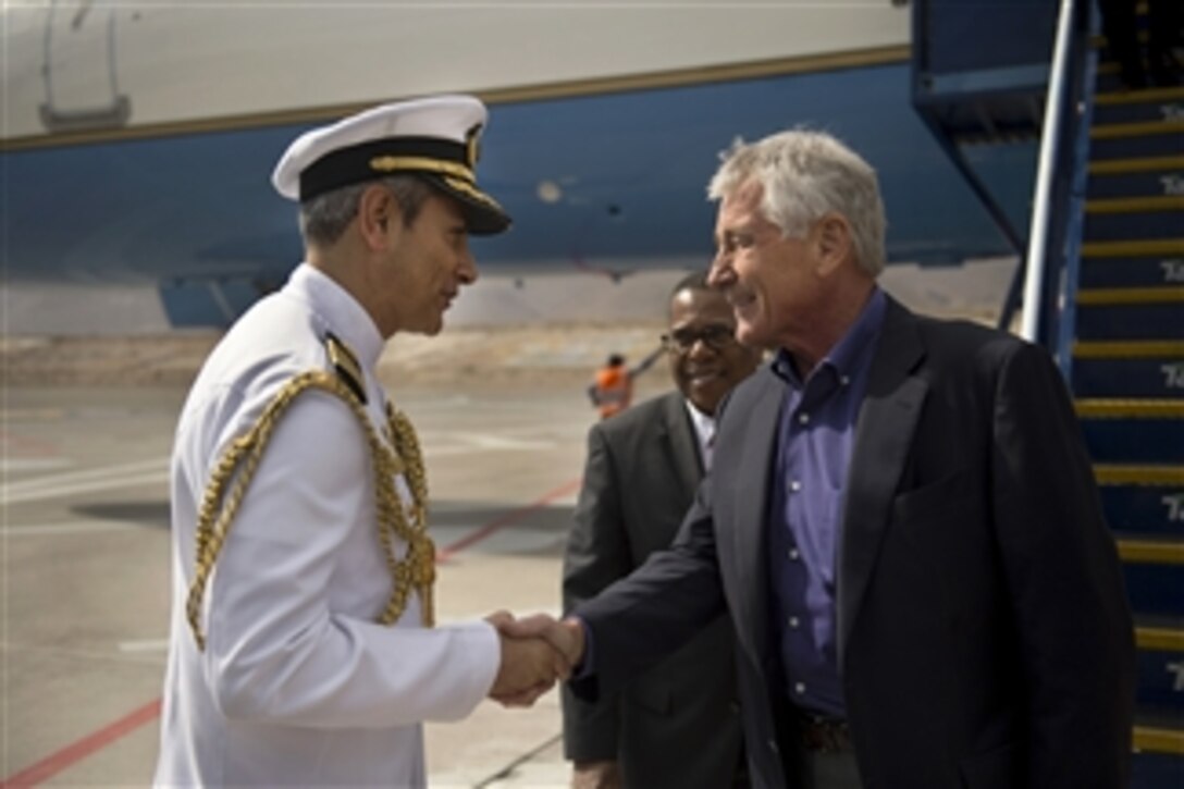 U.S. Defense Secretary Chuck Hagel shakes hands with a Peruvian military official who welcomes him to Arequipa, Peru, Oct. 12, 2014, to attend the 11th Conference of the Defense Ministers of the Americas. Hagel earlier traveled to Colombia and Chile during his six-day trip to South America.