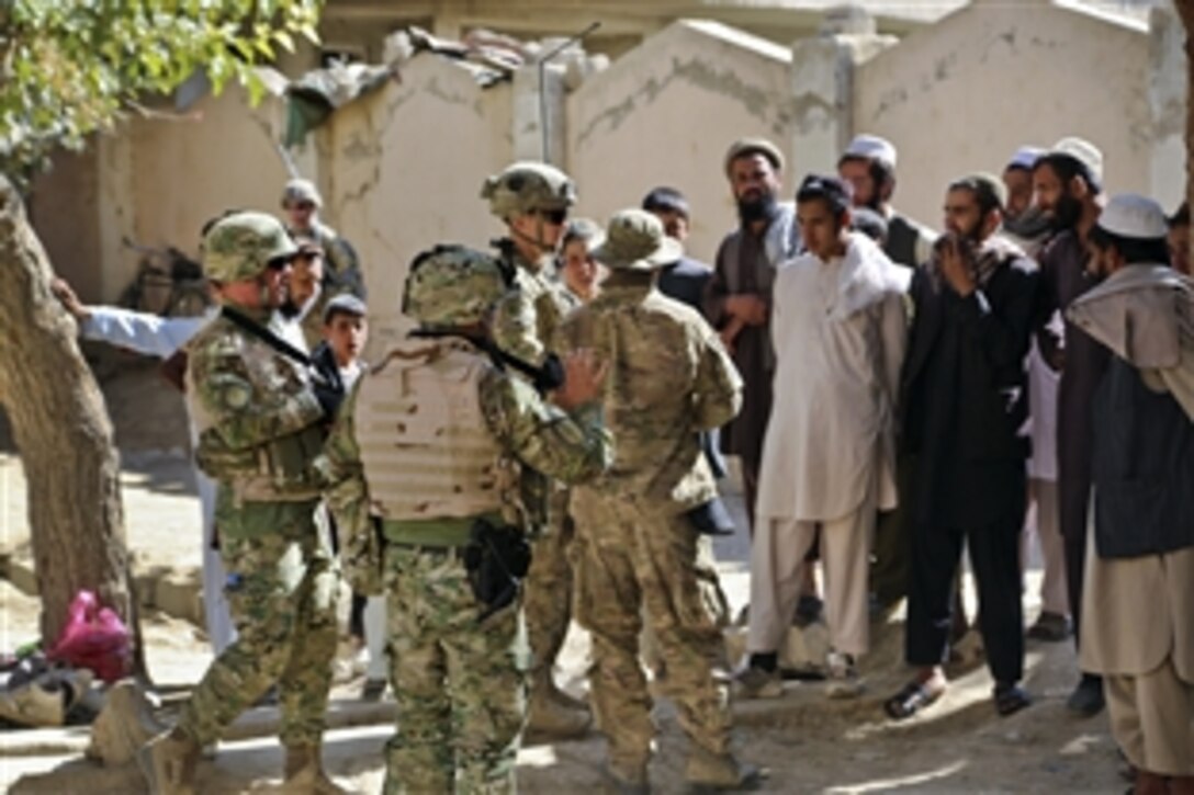 U.S. and Georgian leaders engage with Afghan residents during a foot patrol through the village of Kalanasro in Bagram, Afghanistan, Oct. 11, 2014. The U.S. soldiers, assigned to the 101 Airborne Division's 1st Battalion, 75th Cavalry Regiment, 2nd Brigade Combat Team, offered training on how to correctly patrol. 