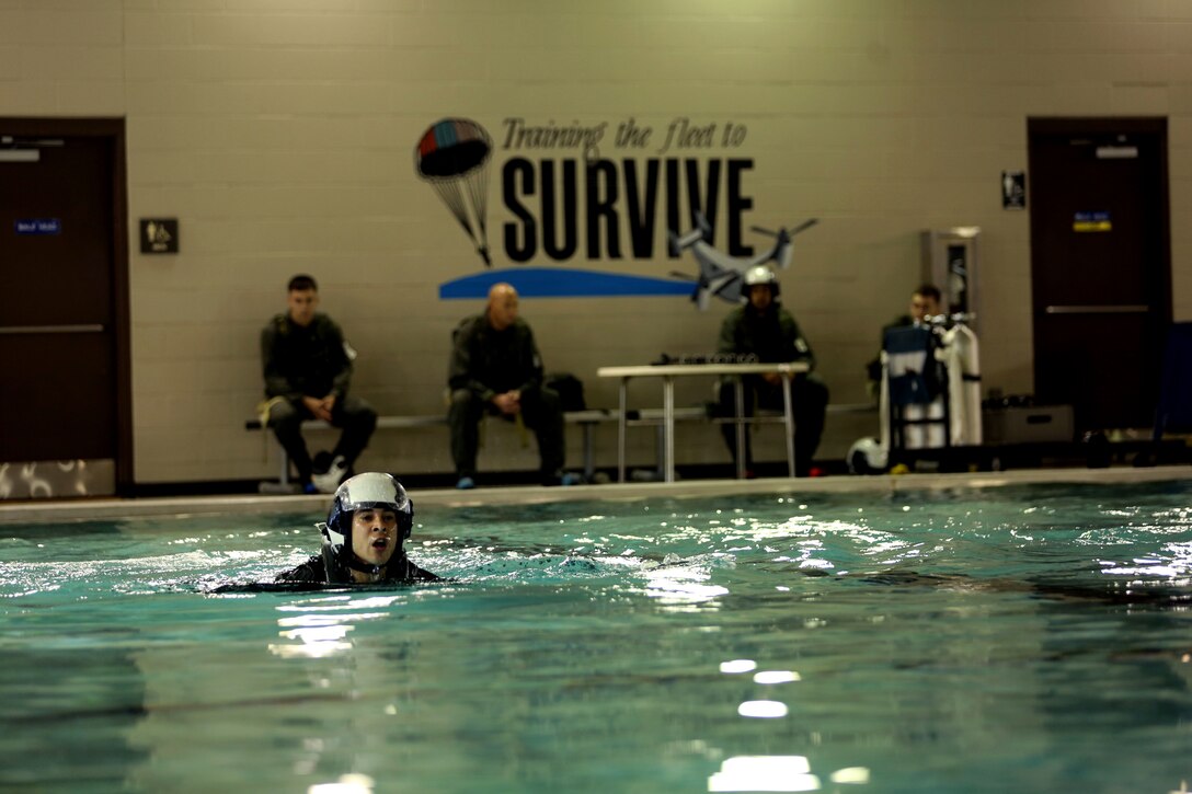 Lance Cpl. Colton Slabaugh performs a 75-meter swim during the survival swimming portion of the survival egress training course at the Aviation Survival Training Center, Marine Corps Air Station Cherry Point, N.C., Oct 8, 2014. Slabaugh is an avionics mechanic with Marine Medium Tiltrotor Squadron 365 (Reinforced) and a native of Medina, Ohio.