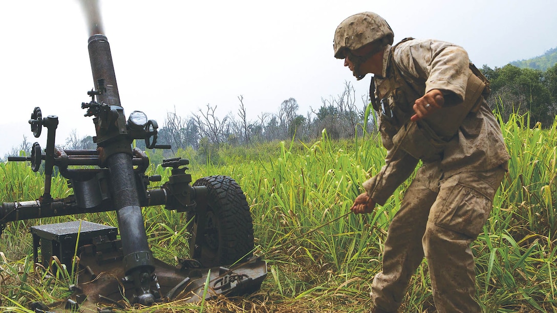 Cpl. Robert Modar, a cannoneer with Charlie Battery, 1st Battalion, 12th Marine Regiment, pulls the lanyard on an M327 Expeditionary Fire Support System Oct. 7, 2014 during a training and readiness evaluation. The Marines from 1st Bn., 12th Marines, were getting evaluated on timeliness of getting the 120 mm rounds fired off as preparation for an upcoming deployment. 