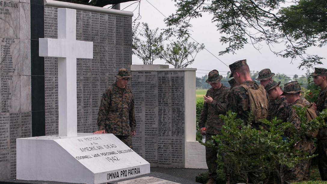 U.S. Marines read a tombstone memorial while visiting the Bataan Death March Memorial at Capas National Shrine during Amphibious Landing Exercise 15, Oct. 8, 2014. More than 100 Marines visited the memorial over two days to learn more about the events of World War II that occurred in the Philippines. PHIBLEX is an annual, bilateral training exercise conducted by members of the Armed Forces of the Philippines alongside U.S. Marine and Navy Forces focused on strengthening the partnership and relationships between the two nations across a range of military operations including disaster relief and complex expeditionary operations. The Marines are with Combat Logistics Battalion 31, 31st Marine Expeditionary Unit.