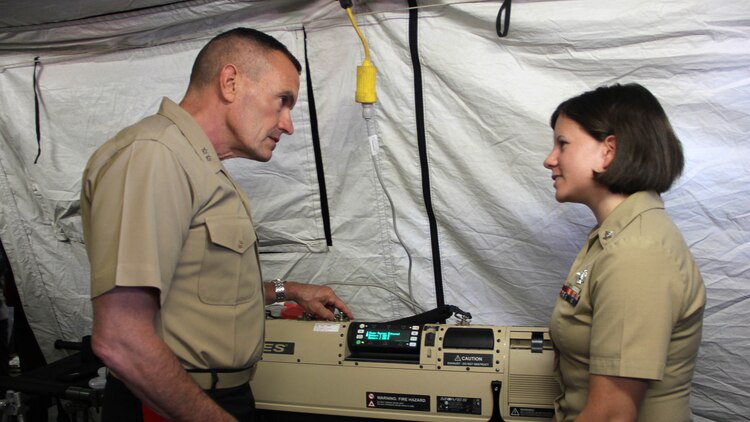 Maj. Gen. Vincent A. Coglianese, the commanding general of 1st Marine Logistics Group, discusses medical equipment used by the Shock Trauma Platoon with a Sailor at the San Francisco Fleet Week 2014 Humanitarian Assistance and Disaster Relief Village in Marina Green, San Francisco, Oct. 11.  In partnership with the U.S. Navy, the Marine Corps is a force perfectly designed and suited for both crisis response and maritime security.  No forces are more suitable to addressing emerging HA/DR needs than naval amphibious forces.