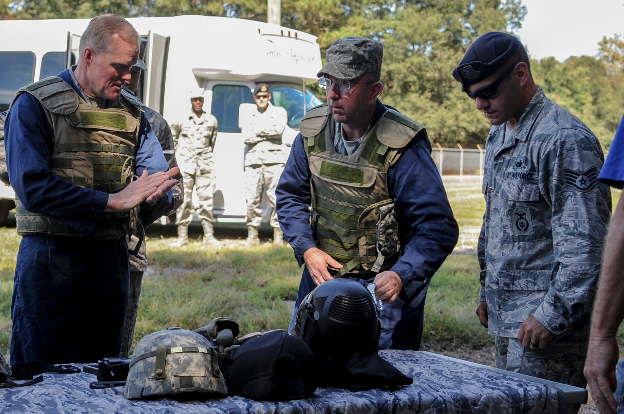 From left, Chief Master Sgt. of the Air Force James Cody, Chief Master Sgt. Jeffrey Craver and Staff Sgt. John Makripodis gear up before participating in a tactical operation exercise at the 4th Security Forces Squadron shoot house  Oct. 9, 2014, at Seymour Johnson Air Force Base, N.C. Carver is 4th Fighter Wing command chief and Makripodis is with the 4th SFS. (U.S. Air Force photo/Airman 1st Class Ashley Thum)