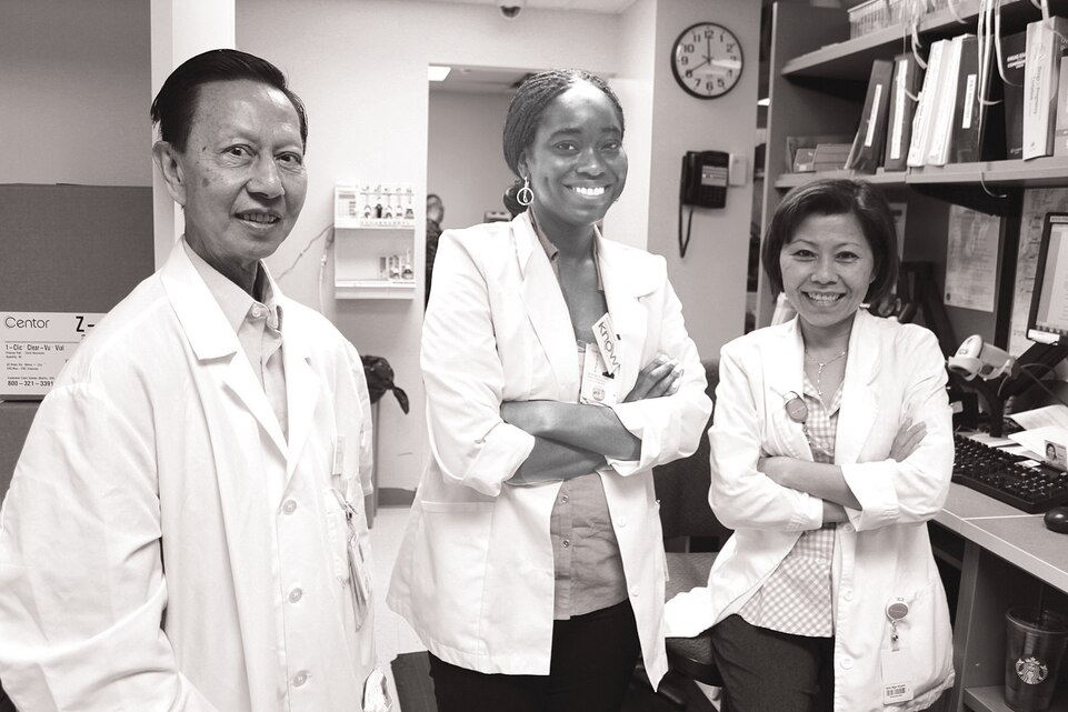 Pharmacists at Naval Health Clinic Quantico, Hoai-Tien Nguyen (left), Erica Jefferson and Kim-Nga Huynh stand behind the counter at the clinic, Oct. 8. 