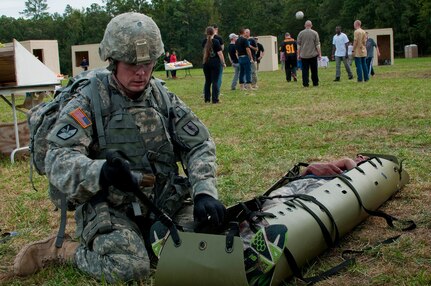 Army Staff Sgt. Devin Jameson Sr., a combat medic with the Utah Army National Guard's 2nd Battalion, 640th Regiment (Regional Training Institute), evaluates a casualty during the warrior task and battle drill event at the 2014 Department of the Army Best Warrior Competition, Oct. 7, 2014 at Fort Lee, Va. Jameson represented the Army National Guard as its top noncommissioned officer of the year. 