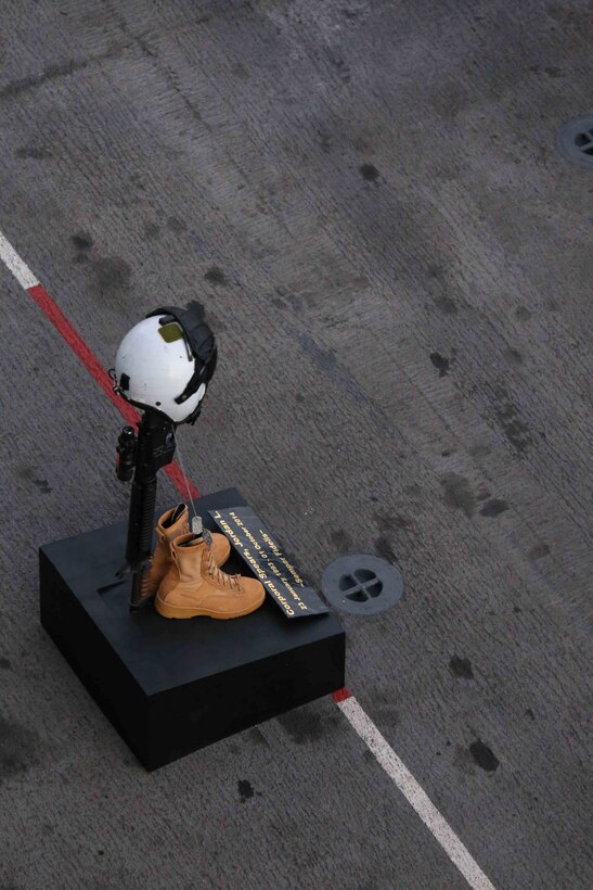 The memorial stand paying tribute to Cpl. Jordan Spears sits on the flight deck of the USS Makin Island (LHD 8) during his memorial, Oct. 8. The 11th MEU is deployed with the Makin Island Amphibious Ready Group as a theater reserve and crisis response force throughout U.S. Central Command and the U.S. 5th Fleet area of responsibility.  (U.S. Marine Corps photo by Capt. Joshua Diddams/RELEASED)