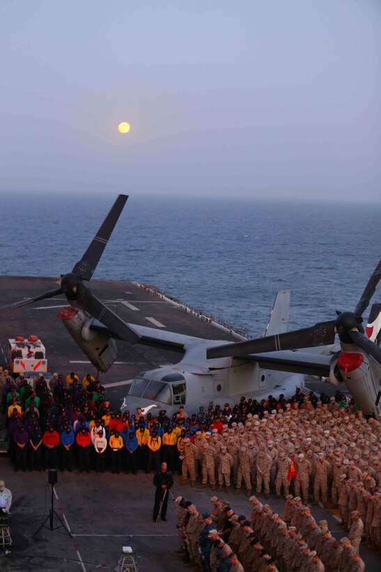 Marines with the 11th Marine Expeditionary Unit (MEU) and sailors with the USS Makin Island (LHD 8) bow their heads during a prayer at the memorial ceremony for Cpl. Jordan Spears on the flight deck of the USS Makin Island, Oct. 8. Cpl. Spears was lost at sea Oct. 1 during flight operations off the Makin Island. The 11th MEU is a forward-deployed, flexible sea-based Marine Air-Ground Task Force embarked with the Makin Island Amphibious Ready Group in the U.S. 5th Fleet area of responsibility. (U.S. Marine Corps photo by Capt. Joshua Diddams/RELEASED)