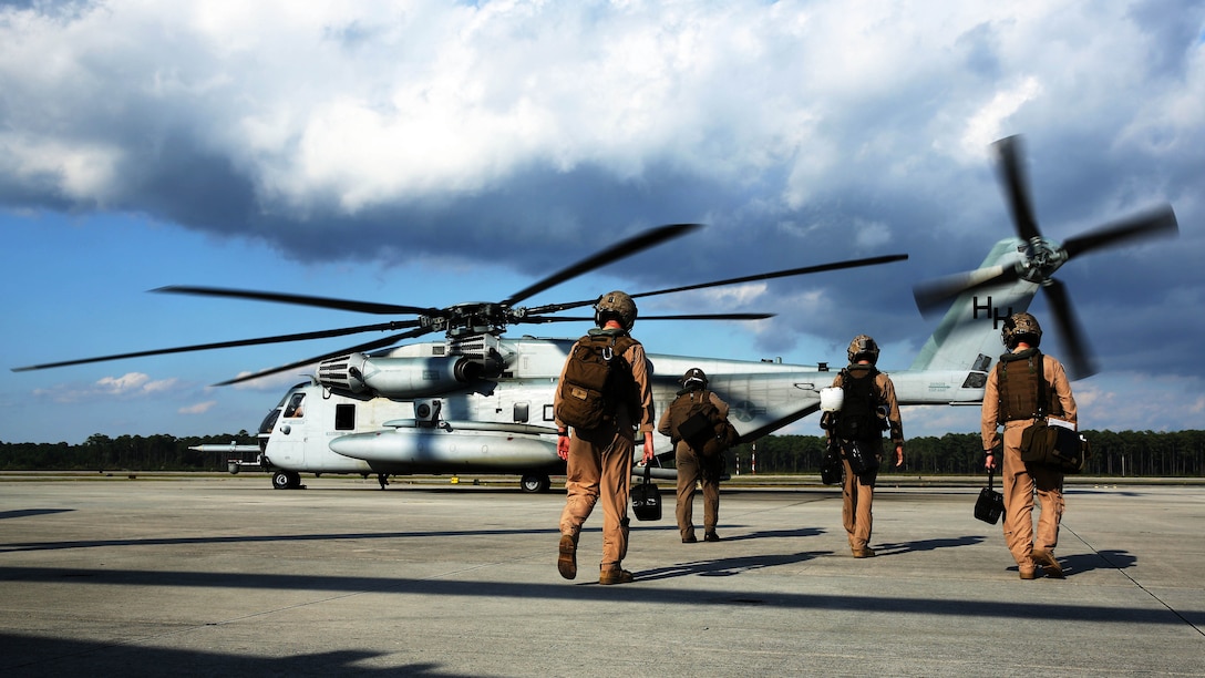 Pilots and crew members with Marine Heavy Helicopter Squadron 366 board a CH-53E Super Stallion at Marine Corps Air Station Cherry Point, North Carolina, before conducting aerial refueling training off the coast of North Carolina Oct. 8, 2014.