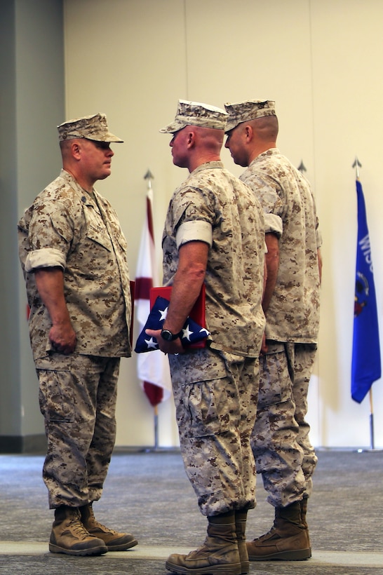 Master Gunnery Sgt. Steven C. Post, left, receives his retirement certifications and an American flag from Col. John C. Vara and Sgt. Maj. Thomas W. Foster during a retirement ceremony at Marine Corps Air Station Cherry Point, N.C., Oct. 8, 2014. Post dedicated three decades of his life to the Marine Corps and finished his career as an aviation maintenance chief with Marine Wing Headquarters Squadron 2. Vara is the commanding officer of Marine Aircraft Group 26 and Foster is the sergeant major of MWHS-2.