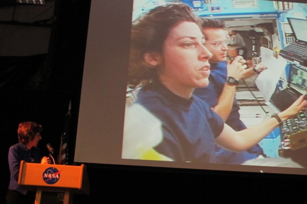 Dr. Ellen Ochoa, keynote speaker, shows audience video coverage from her first space shuttle mission during Hispanic Heritage Month Program.
