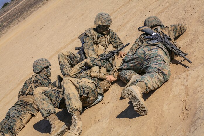 Recruits of Fox Company, 2nd Recruit Training Battalion, carry a simulated casulty during the Crucible Confidence Course at Edson Range aboard Marine Corps Base Camp Pendleton, Calif., Sept. 30.  Recruits who failed to pay attention to details or did not stay together as a fire-team were penalized by having to redo the entire event but with one of their team members as a simulated casualty.