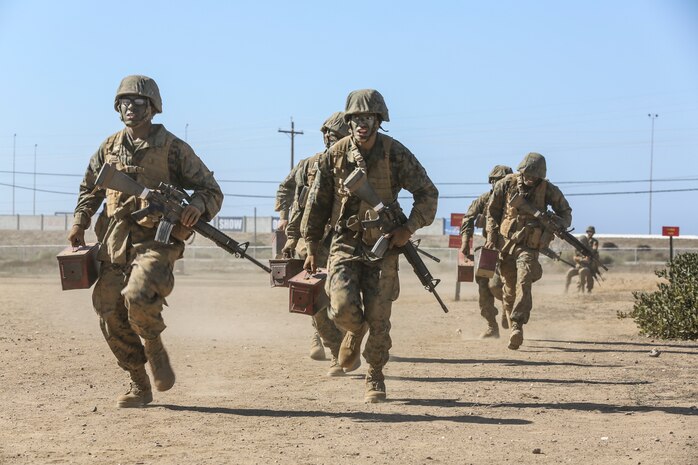Recruits of Fox Company, 2nd Recruit Training Battalion, run with ammunition cans during the Crucible Confidence Course at Edson Range aboard Marine Corps Base Camp Pendleton, Calif., Sept. 30.  Recruits who pushed the hardest and fastest were rewarded by being able to move on to the next obstacle, but those who didn’t had to perform the run again.