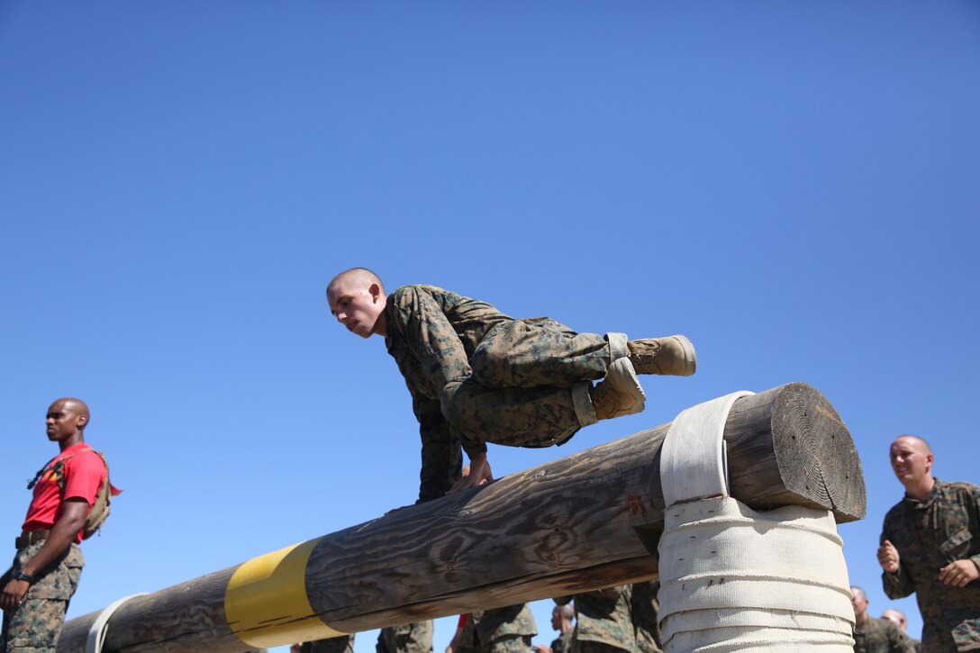 A recruit with Company A, 1st Recruit Training Battalion, hurdles over a log jump while running the obstacle course at Marine Corps Recruit Depot San Diego, Calif., Oct. 2.  The hurdle is the first of eight obstacles in the course.  Recruits run the course several times during recruit training.