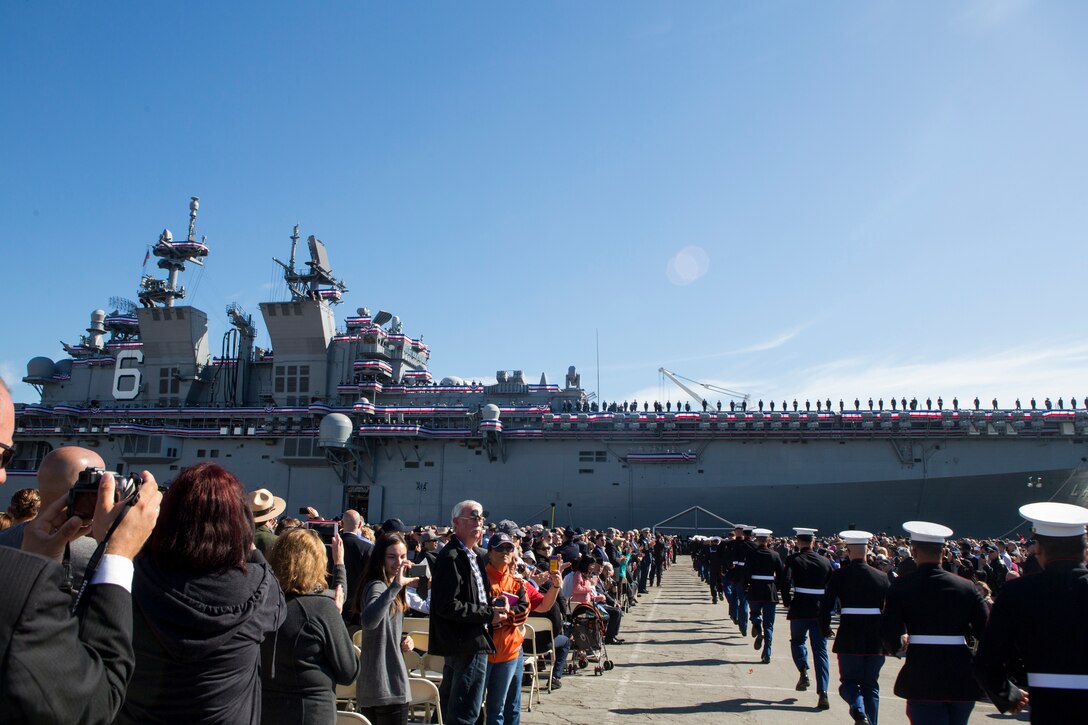 U.S. Marines and Sailors run toward the USS America (LHA-6) to man the ship at the commissioning of USS America (LHA-6) during San Francisco Fleet Week on Oct. 11, 2014. The commissioning signifies the start of the new ship's life as part of the Navy Fleet. San Francisco Fleet Week hosted Marines and Sailors that showcased the capabilities of humanitarian assistance disaster relief that the military offers in case of emergencies. (U.S. Marine Corps photo by Cpl. Rodion Zabolotniy/Released)