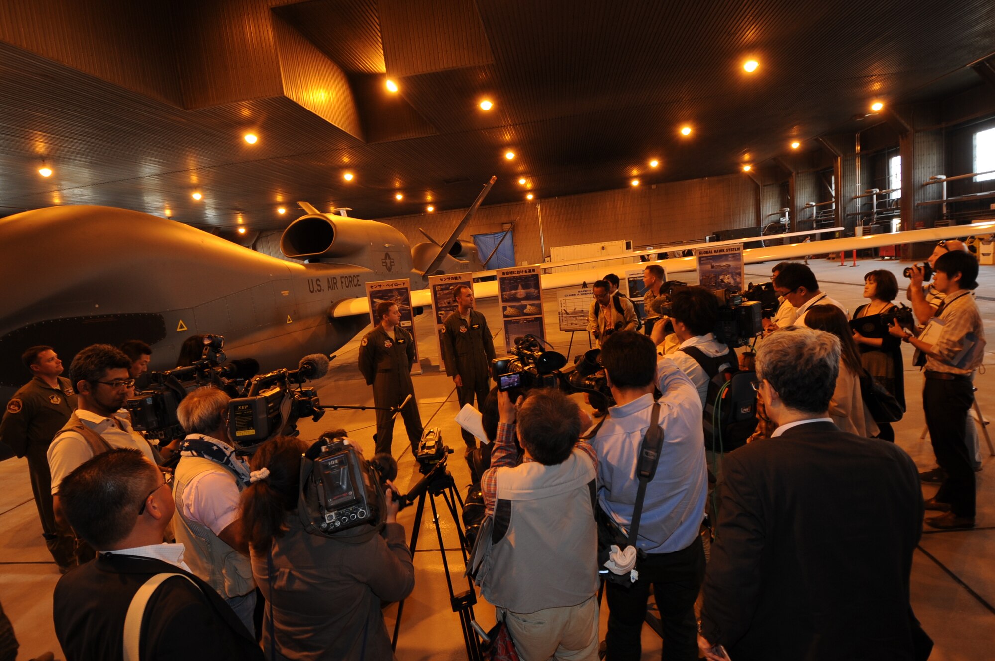 Members of the Japanese media surround the RQ-4 Global Hawk during a meet and greet at Misawa Air Base, Japan, May 30, 2014. The Global Hawk’s pilots held a press conference for media and explained the aircraft’s capabilities in order to introduce the aircraft to the Japanese public. (U.S. Air Force photo by Tech. Sgt. April Quintanilla/Released)