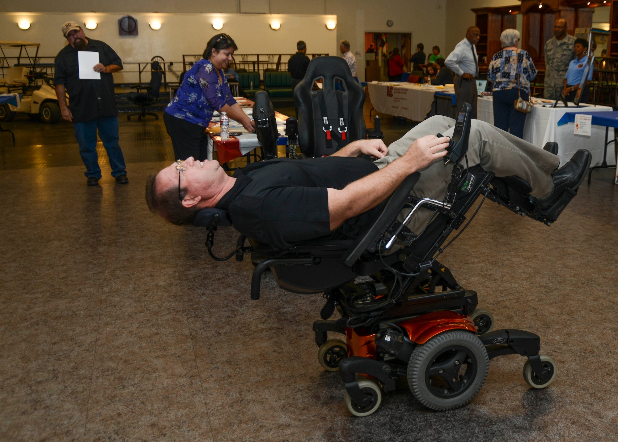 Access Medical representative Kevin Swafford, demonstrates the tilt and decline function in a custom-built wheelchair. The chair is meant to be a health tool, not just a means of getting around. (U.S. Air force photo by Rebecca Amber)