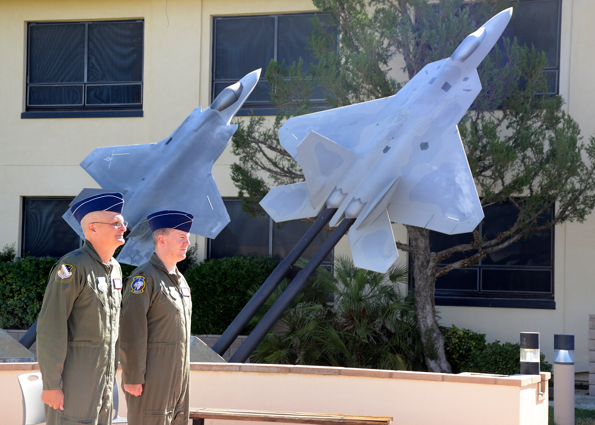 Maj. Gen. Arnold Bunch Jr. (left), Air Force Test Center commander, and Maj. Todd Abshire, AFTC Safety Office, stand at attention as the orders are posted for his Air Medal to be awarded for his recent deployment to Afghanistan. (U.S. Air Force photo by Kenji Thuloweit)