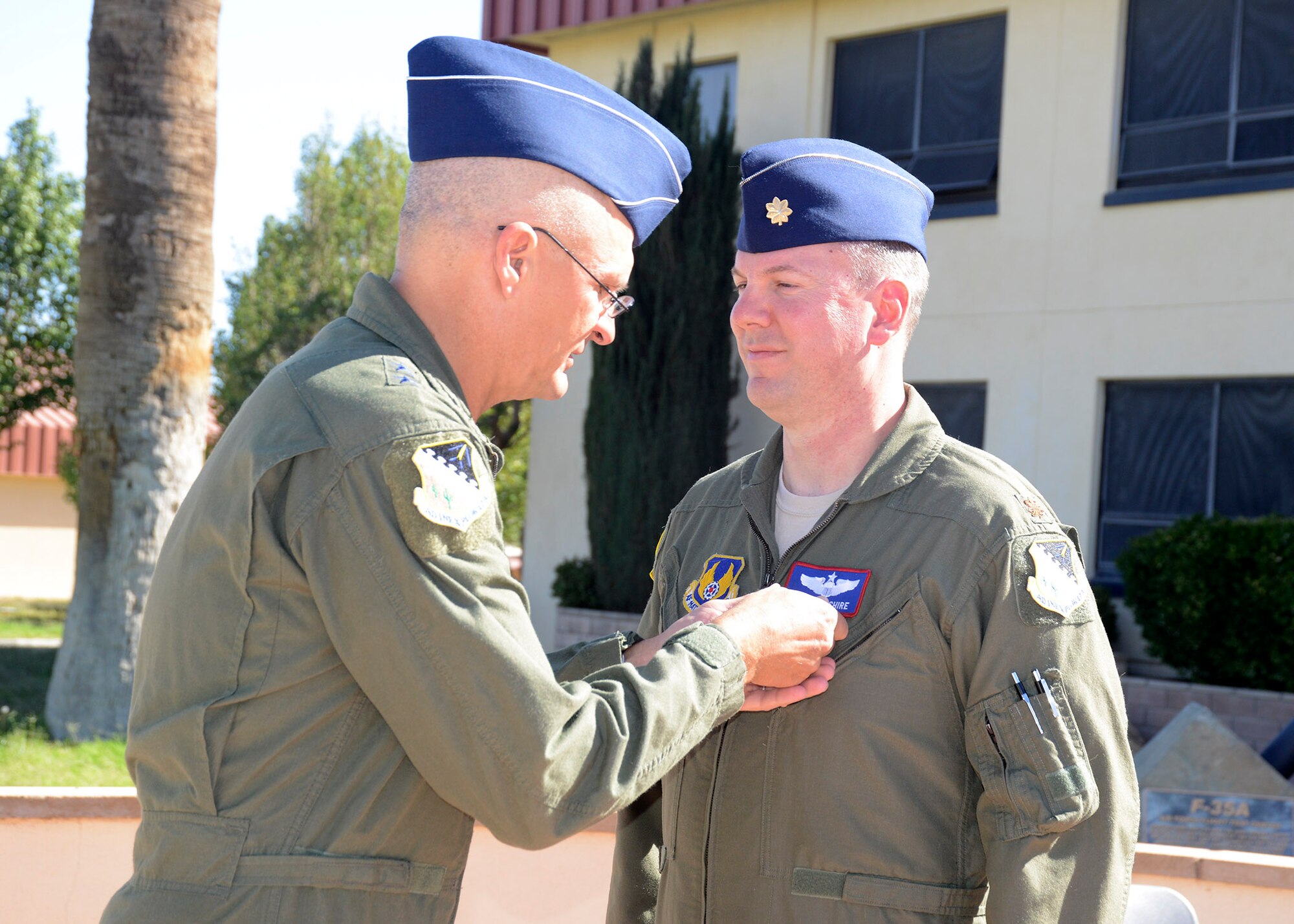 Maj. Gen. Arnold Bunch Jr. (left), Air Force Test Center commander, pins the Air Medal on Maj. Todd Abshire during a ceremony in front of Bldg. 1, Oct. 14. Abshire was awarded a total of three medals, two Air Medals for his recent deployment to Afghanistan, and the Meritorius Service Medal for distinguising himself at Edwards by standing up the AFTC's Safety Office. He spent two years on center staff, of which the last 365 was deployed to Afganistan. (U.S. Air Force photo by Kenji Thuloweit)