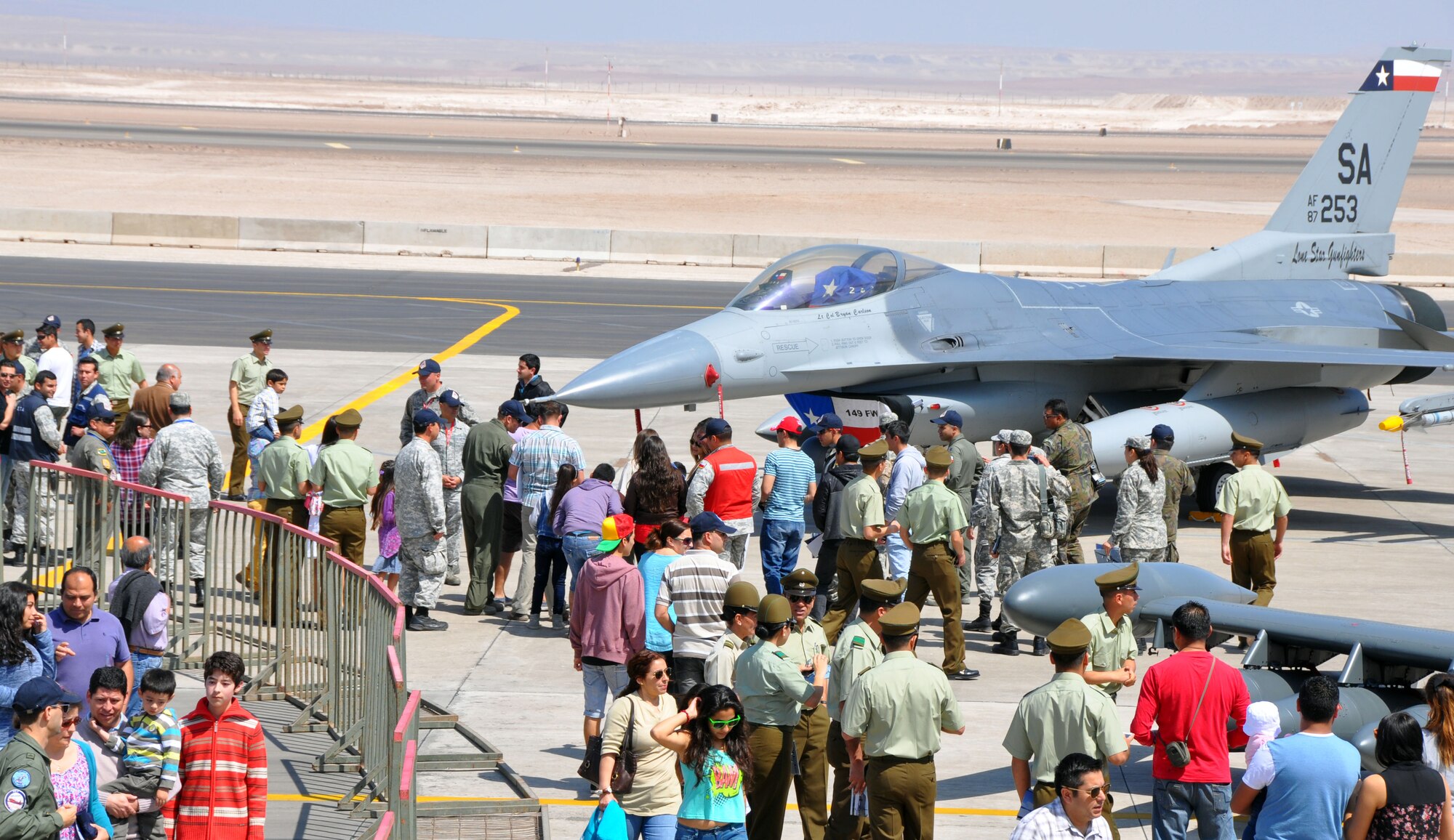 Onlookers from various agencies and branches of the Chilean government, along with their families, visit with Airmen from the Texas Air National Guard's 149th Fighter Wing during an Open Day at Exercise Salitre 2014 at Cerro Moreno Air Base, Chile. The exercise also includes the air forces of Brazil, Argentina and Uruguay and focuses on strengthening partnerships and interoperability in a coalition format. (U.S. Air Force photo by Capt. Bryan Bouchard/Released)