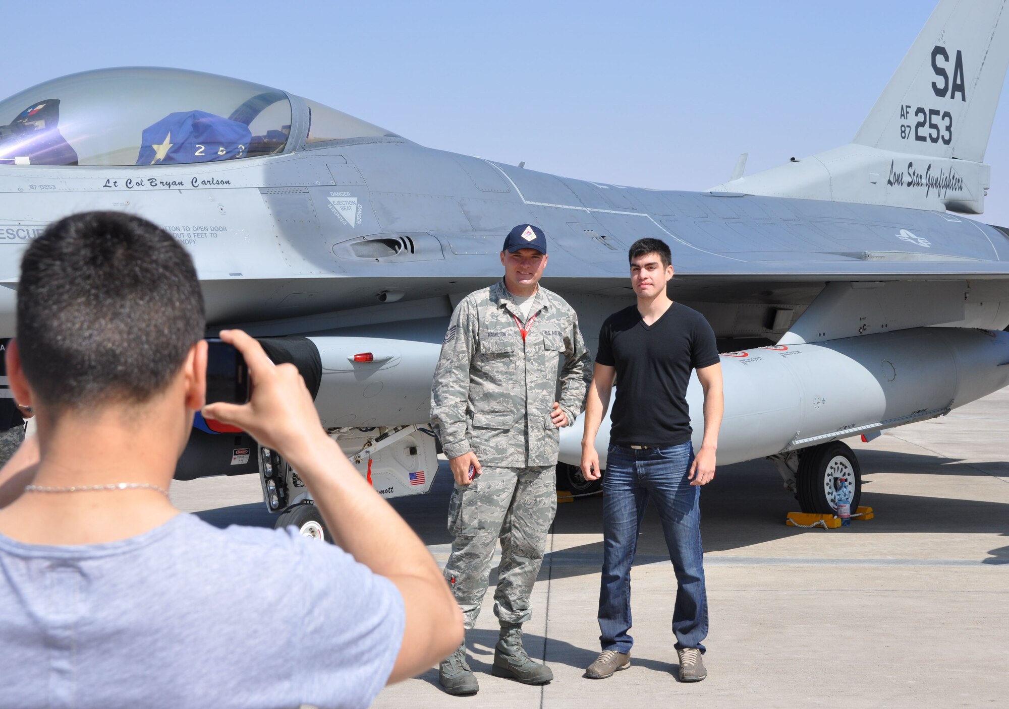 Tech. Sgt. Christopher Hamilton, from the Texas Air National Guard's 149th Fighter Wing at Joint Base San Antonio, Texas, poses for a photo with a member of the Chilean armed forces during an Open Day at Exercise Salitre 2014. The exercise, hosted by the Chilean air force, also involves the air forces of the U.S., Brazil, Argentina and Uruguay and focuses on enhancing interoperability between the participating nations. Exercise Salitre 2014 wraps up October 16. (U.S. Air Force photo by Capt. Bryan Bouchard/Released)