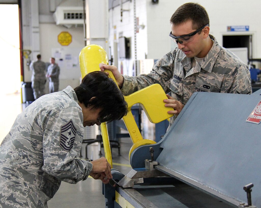 TRAVIS AIR FORCE BASE, Calif. -- During the September unit training assembly (UTA), Senior Airman Steven Young, 349th Maintenance Squadron, was selected to demonstrate the basic metal hand forming technique with Command Chief Kelly. (U.S. Air Force photo/ Staff Sgt. Emil Tomas)