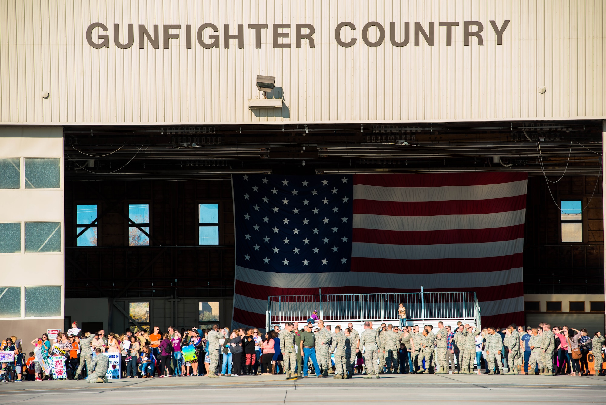 Airmen from the 391st Fighter Squadron returned from a six-month deployment to the Asia-Pacific region Oct. 10, 2014. Gunfighters and family members gather outside the 391st Bold Tigers hanger awaiting the arrival of their loved ones. (U.S. Air Force photo by Airman Connor J. Marth/RELEASED)