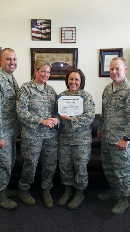 Staff Sgt. Jennifer Emerson, 50th Space Wing, receives the Top 3 Performer of the Month award, from the Top 3 organization. During September, Emerson set herself apart from her peers by embracing one of the Air Force’s core values -- service before self.  Emerson contributed her time and job knowledge to the successful week of events that led up to the 50th Space Wing Senior NCO induction banquet. On a separate occasion, she made it possible for the family members of First Term Airmen Center graduates to have a class photo sent home along with a personal letter from the wing commander. (Courtesy photo)