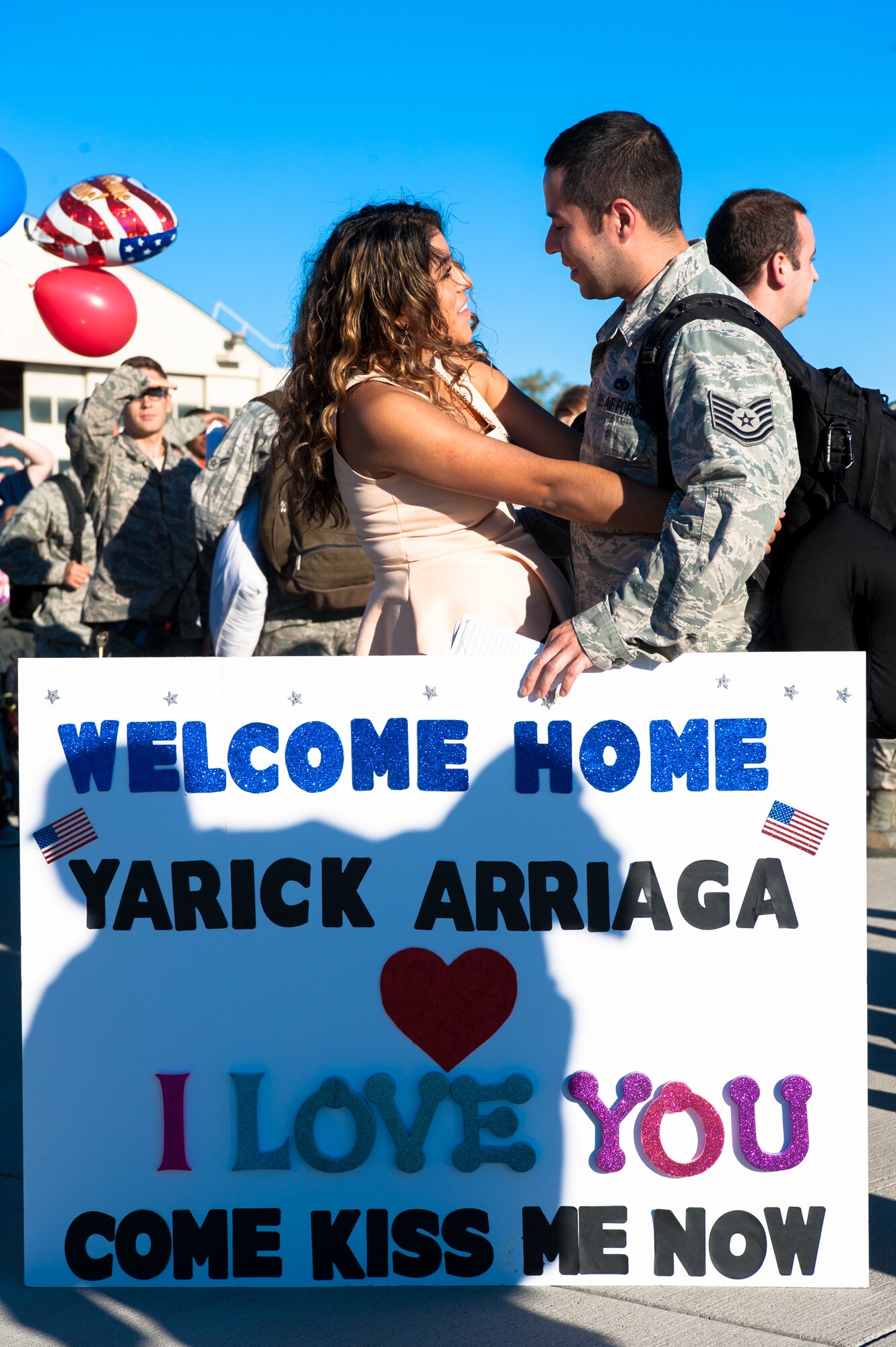 Tech. Sgt. Yarick Arriaga, 366th Aircraft Maintenance Squadron weapons expediter, embraces his loved one after returning from his deployment Oct. 10, 2014, at Mountain Home Air Force Base, Idaho.  Airmen’s families waited for the arrival of their loved ones who had been deployed for the past six months. (U.S. Air Force photo by Airman 1st Class Jeremy L. Mosier/RELEASED)