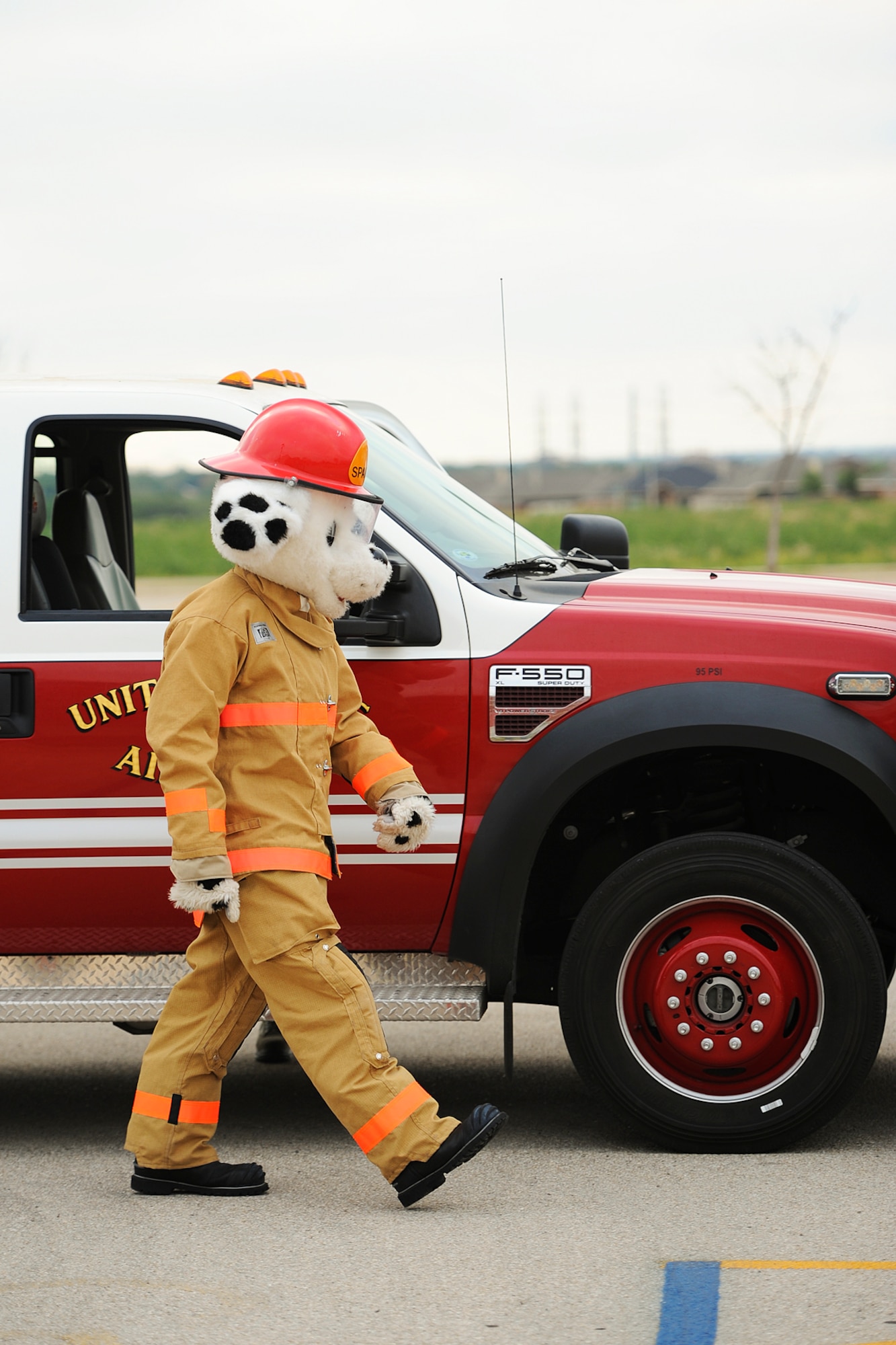 SAN ANGELO, Texas – Sparky, Goodfellow Fire Department mascot, exits a rescue truck at the Lamar Elementary School parking lot Oct. 6. Sparky made an appearance at Lamar Elementary to teach children about fire safety and prevention for Fire Prevention Week. (U.S. Air Force photo/ Airman 1st Class Devin Boyer)