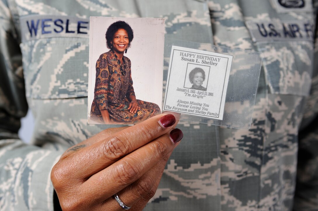 U.S. Air Force Senior Master Sgt. Janna’ Wesley, Air Combat Command Enlisted Professional Military Education functional manager, holds mementoes of her mother, Susan Shelley, in honor of Breast Cancer Awareness Month at Langley Air Force Base, Va., Oct. 10, 2014. Wesley keeps the mementoes on her at all times. (U.S. Air Force photo illustration by Staff Sgt. Natasha Stannard/Released)