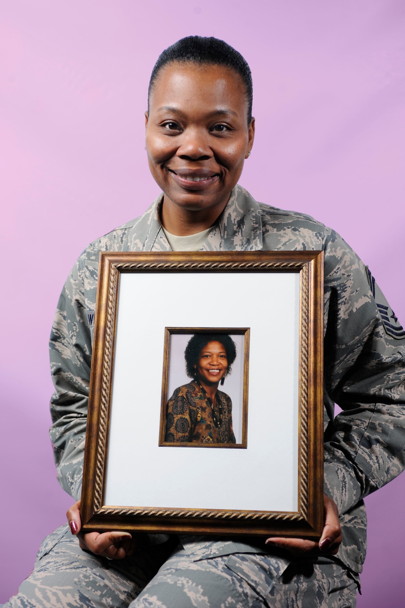 U.S. Air Force Senior Master Sgt. Janna’ Wesley, Air Combat Command Enlisted Professional Military Education functional manager, holds a photo of her mother, Susan Shelley, in honor of Breast Cancer Awareness Month at Langley Air Force Base, Va., Oct. 10, 2014. Shelley’s breast cancer went into remission, but, the cancer later moved to her liver and brain eventually taking her life. (U.S. Air Force photo illustration by Staff Sgt. Natasha Stannard/Released)
