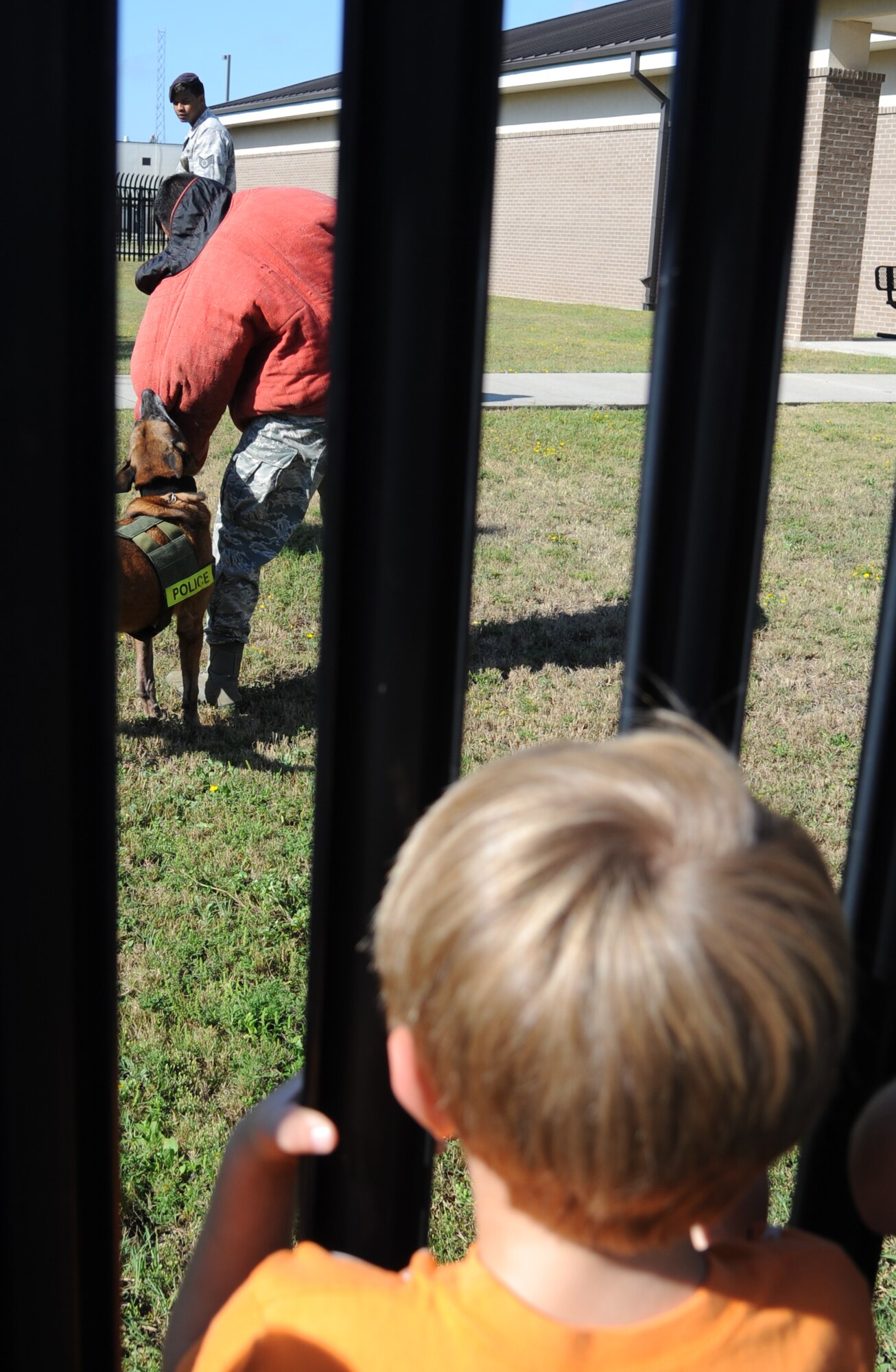 Staff Sgt. Jeremy Hayes, 81st Security Forces Squadron, and his military working dog, Mmaura, provide a demonstration to attendees during Operation Hero Oct. 11, 2014, at Keesler Air Force Base, Miss.  The event was designed to help children better understand what happens when their parents deploy.  (U.S. Air Force photo by Kemberly Groue)