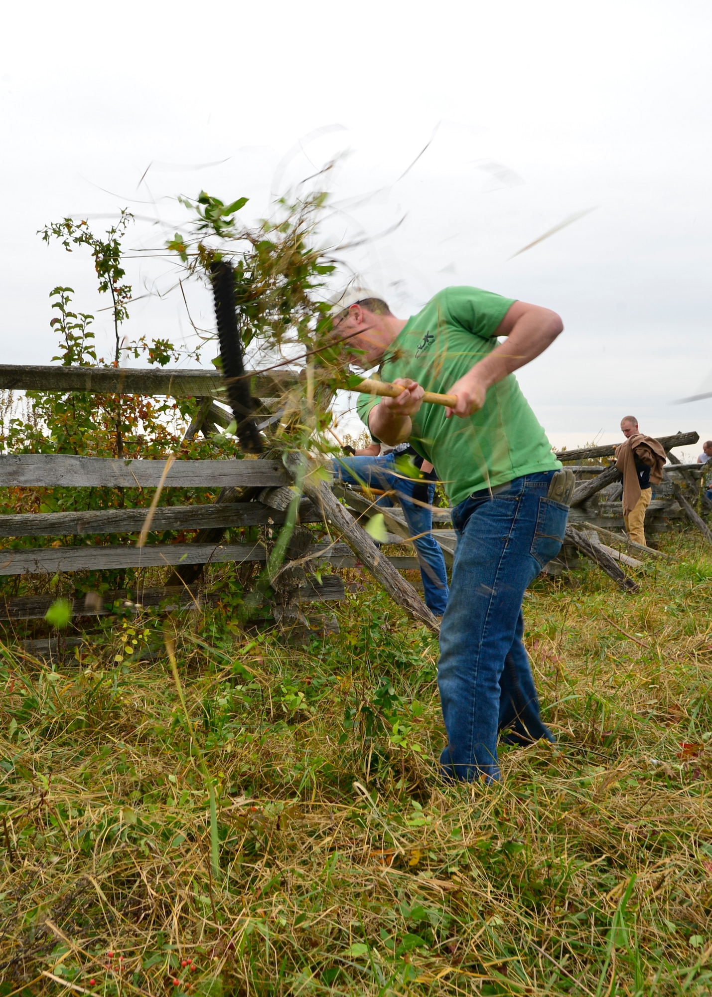 Airman 1st Class Robert Romano, 436th Maintenance Squadron aerospace pulse apprentice, swings a rake to clear overgrown brush along a fence line Oct. 10, 2014, at Gettysburg National Military Park, Pa. Romano was one of more than 100 volunteers from Team Dover that helped cut down brush and rebuild a fence line at Gettysburg. (U.S. Air Force photo/Airman 1st Class William Johnson)