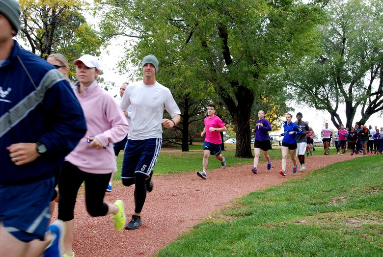 PETERSON AIR FORCE BASE, Colo. — Members of Team Pete take part in a 5km run to raise awareness during Breast Cancer Awareness Month Oct. 10, despite the cold and wet weather. The run was one of many events held during the month as part of Peterson AFB’s effort to help raise awareness about this disease that affects more than 200,000 women each year. (U.S. Air Force photo/Michael Golembesky)