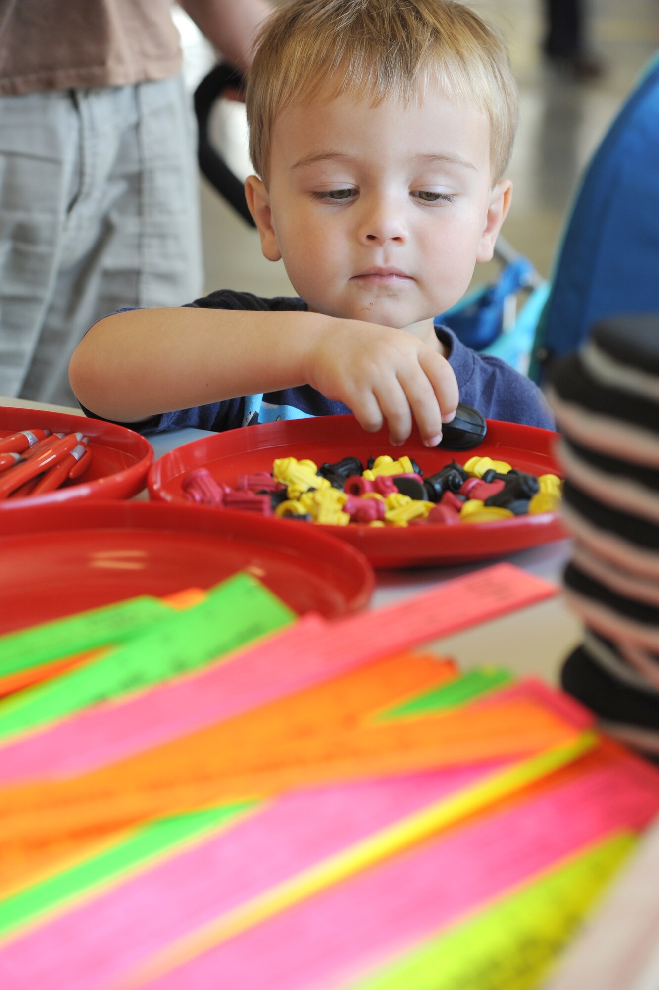 The son of Staff Sgt. William Lyon, 333th Training Squadron, collects gifts during the Keesler Fire Department open house at the fire station Oct. 11, 2014, at Keesler Air Force Base, Miss.  The open house was the conclusion event to fire prevention week. Throughout fire prevention week the Keesler Fire Department conducted random fire drills, toured various facilities with Sparky the Fire Dog, passed out fire safety handouts and fire hats for children and provided stove and fire extinguisher demonstrations.  (U.S. Air Force photo by Kemberly Groue)