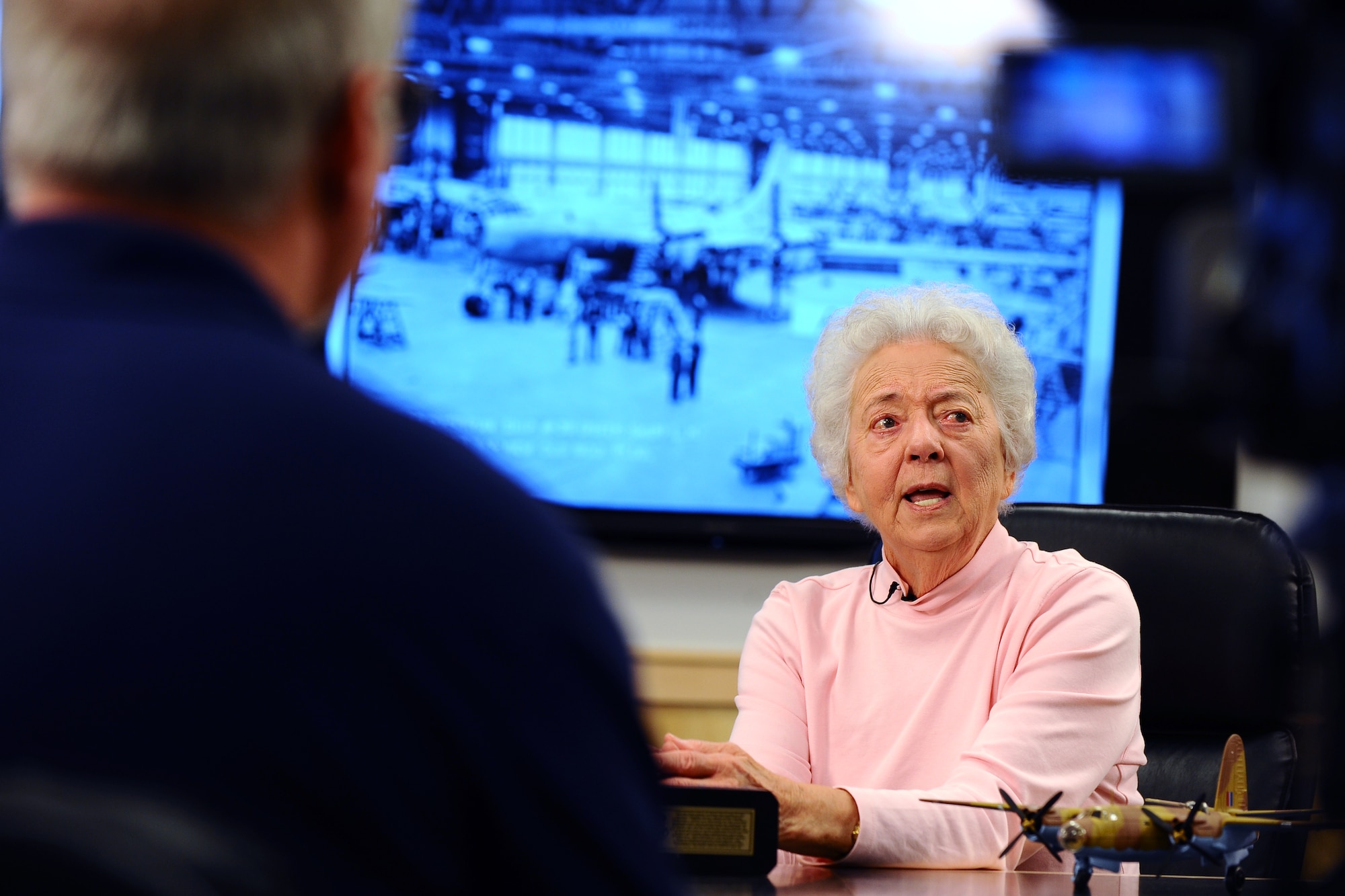 Kathryn  Shudak is interviewed by Kevin Schwandt, 55th Wing Public Affairs videographer, inside of the 55th Civil Engineer’s conference room, located in the Glenn L. Martin Bomber building where she worked as one of many Rosie the Riveters during World War II. Shudak worked long hours in the plant driving the rivets into the B-29 Bombers and was given two 10-minute breaks and a 30-minute lunch, her only relief from working on her feet for the whole shift.  (U.S. Air Force photo by Josh Plueger/Released)