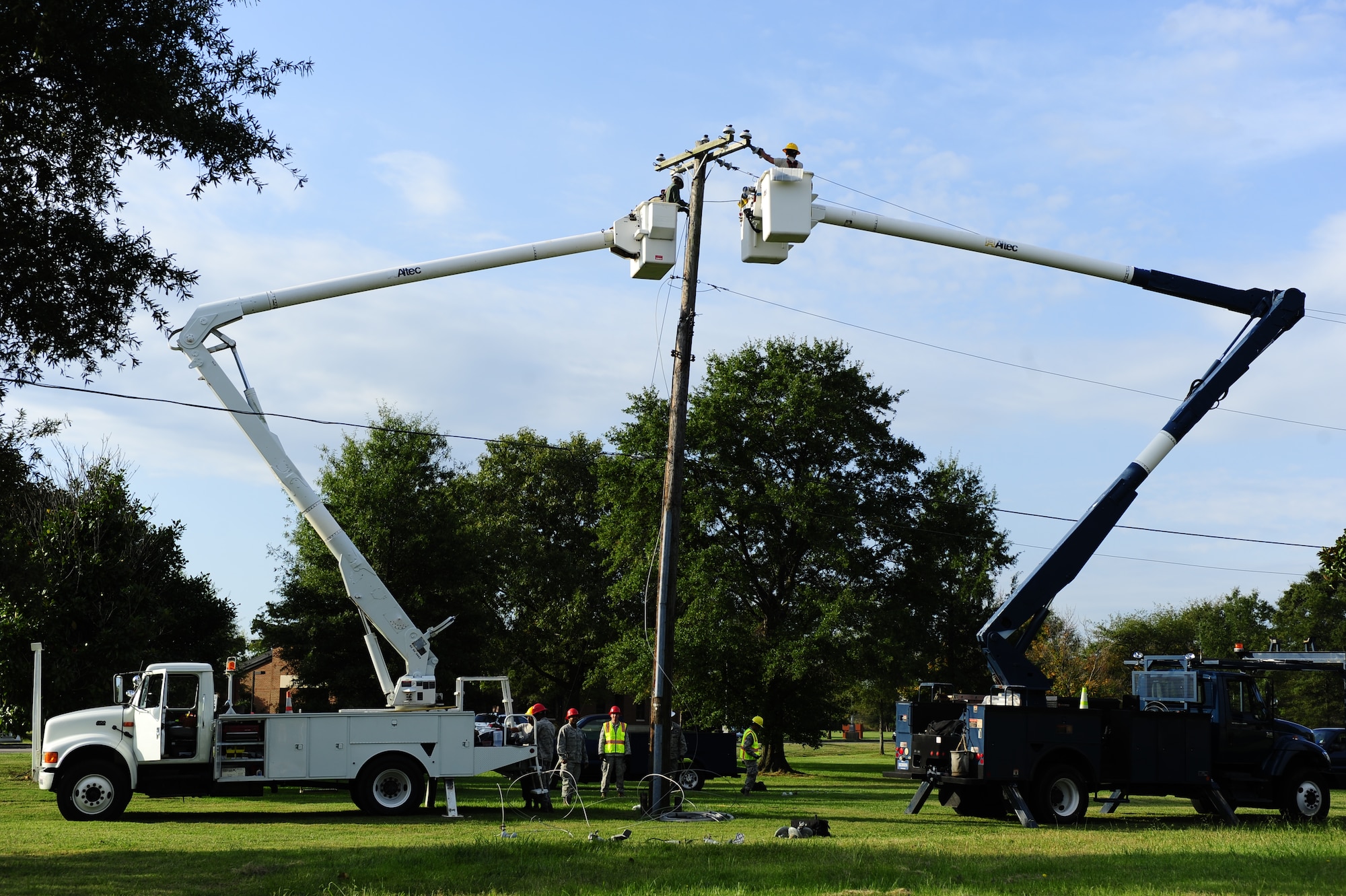 Electricians assigned to the 633rd Civil Engineer Squadron take down inactive power lines at Langley Air Force Base, Va., Oct. 10, 2014. The squadron works on projects like this on Fridays for on-the-job training. (U.S. Air Force photo by Staff Sgt. Natasha Stannard/Released)