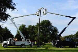 Electricians assigned to the 633rd Civil Engineer Squadron take down inactive power lines at Langley Air Force Base, Va., Oct. 10, 2014. The squadron works on projects like this on Fridays for on-the-job training. (U.S. Air Force photo by Staff Sgt. Natasha Stannard/Released)
