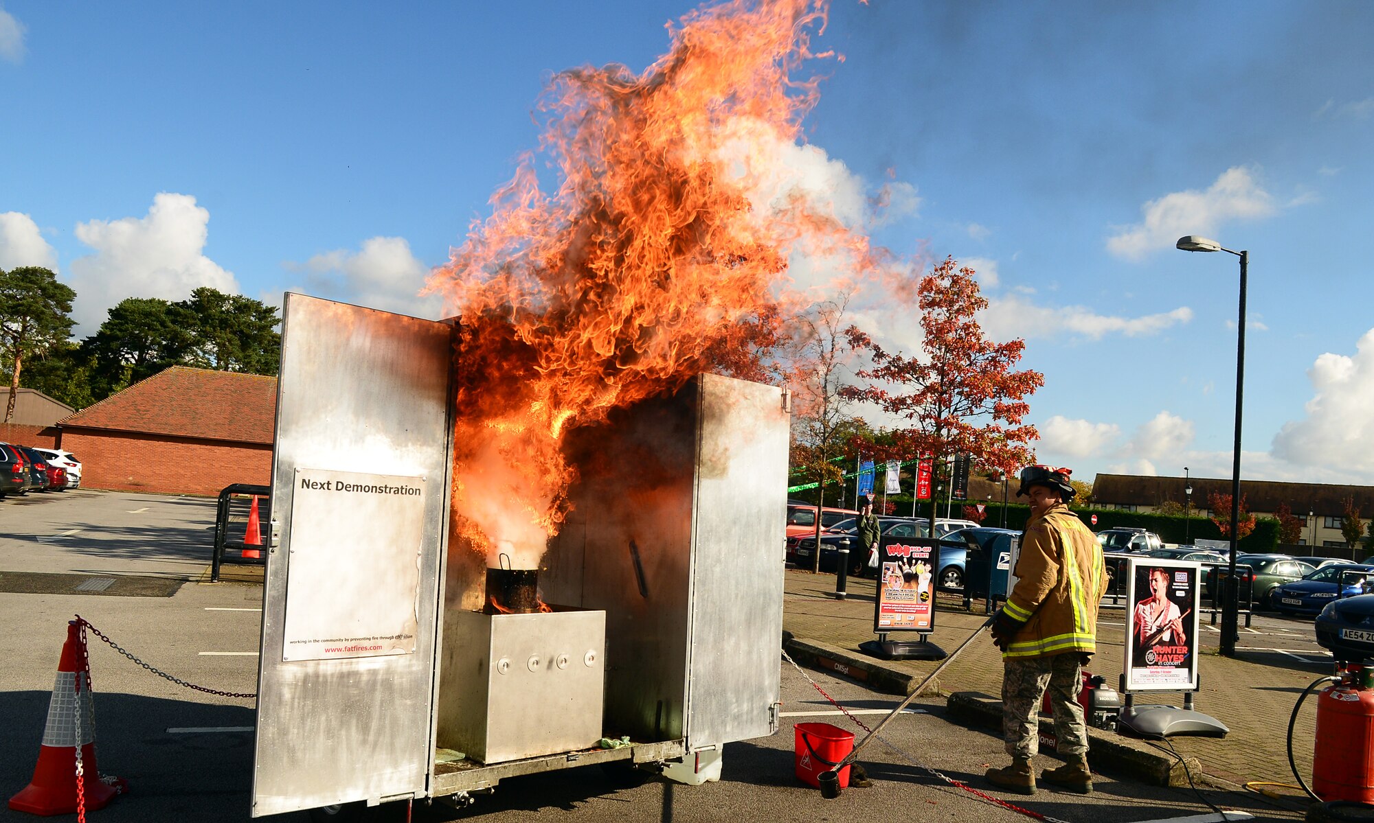 U.S. Air Force Staff Sgt. Anthony Thlang, 100th Civil Engineer Squadron firefighter from Seattle, demonstrates the dangers of a grease fire Oct. 14, 2014, on RAF Mildenhall, England. Thlang emphasized the importance of not attempting to put a grease fire out with water, but to seal the fire with either a lid to the pan or something non-flammable. (U.S. Air Force photo/Airman 1st Class Jonathan Light/Released)