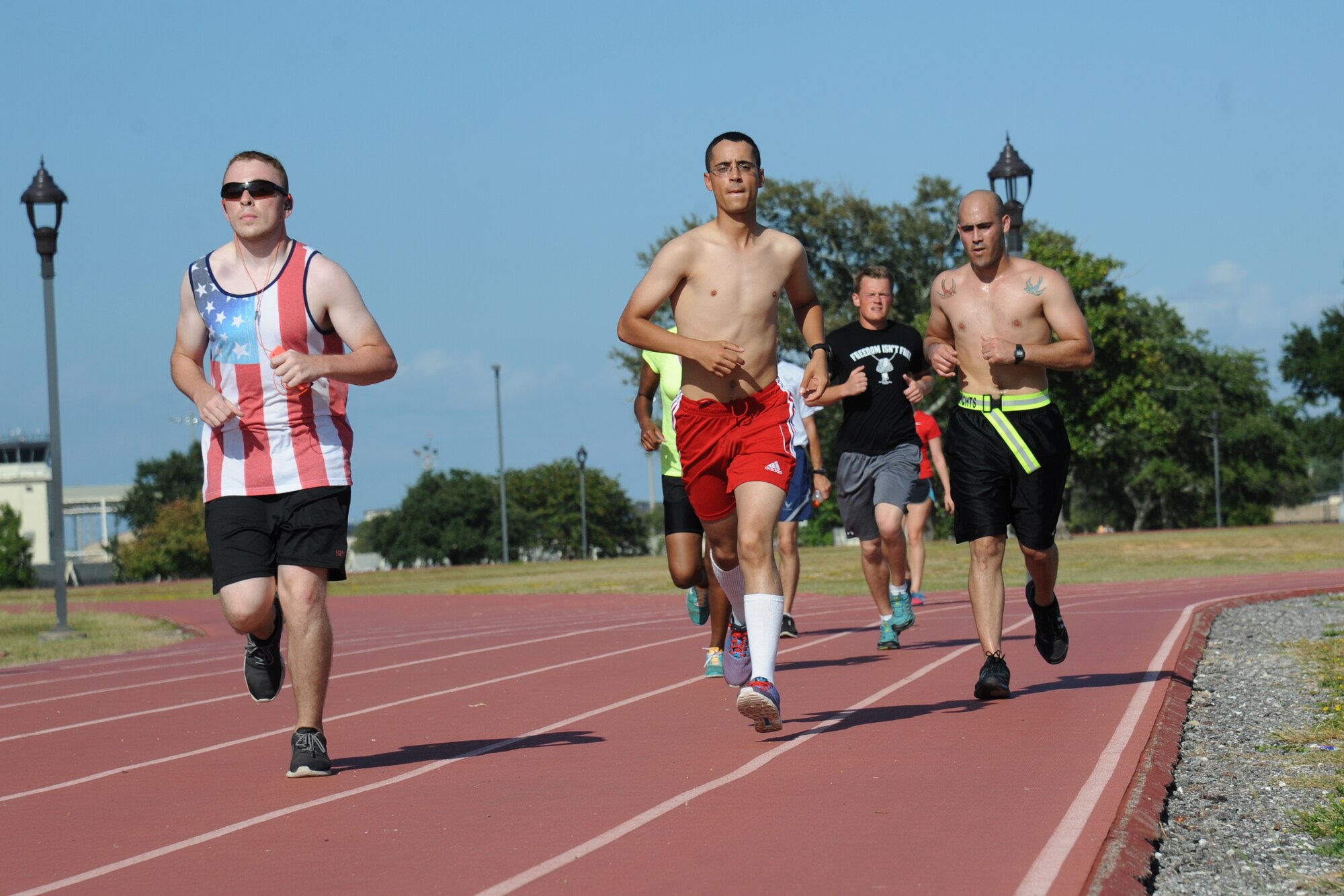 Airman 1st Class Corey Barnett, 81st Logistics Readiness Squadron; Airman Basic David Collins, 335th Training Squadron; Airman Robert Resnik, 334th Training Squadron, and Tech. Sgt. Carlos Rodriguez, 338th Training Squadron, run around the Triangle Track during the 5th annual Dragon Challenge Oct. 10, 2014, Keesler Air Force Base, Miss.  The purpose of the event was to raise funds for the Keesler Fisher House.  (U.S. Air Force photo by Kemberly Groue)