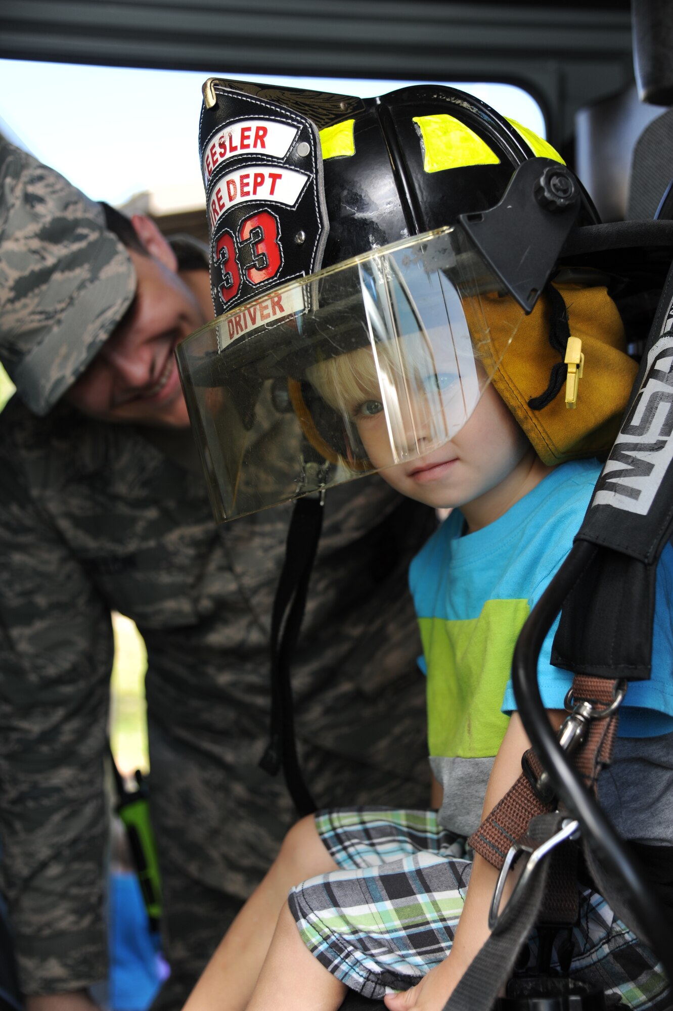 The son of Tech. Sgt. Sherman Dixon, 336th Training Squadron, tours the inside of a fire truck Oct. 7, 2014, at the child development center, Keesler Air Force Base, Miss., during a visit from the Keesler Fire Department for fire prevention week. Throughout fire prevention week the Keesler Fire Department conducted random fire drills, toured various facilities with Sparky the Fire Dog, passed out fire safety handouts and fire hats for children and provided stove and fire extinguisher demonstrations.  The week–long event ended with an open house at the fire station 10 a.m. to 2 p.m. Oct. 11.  (U.S. Air Force photo by Kemberly Groue)