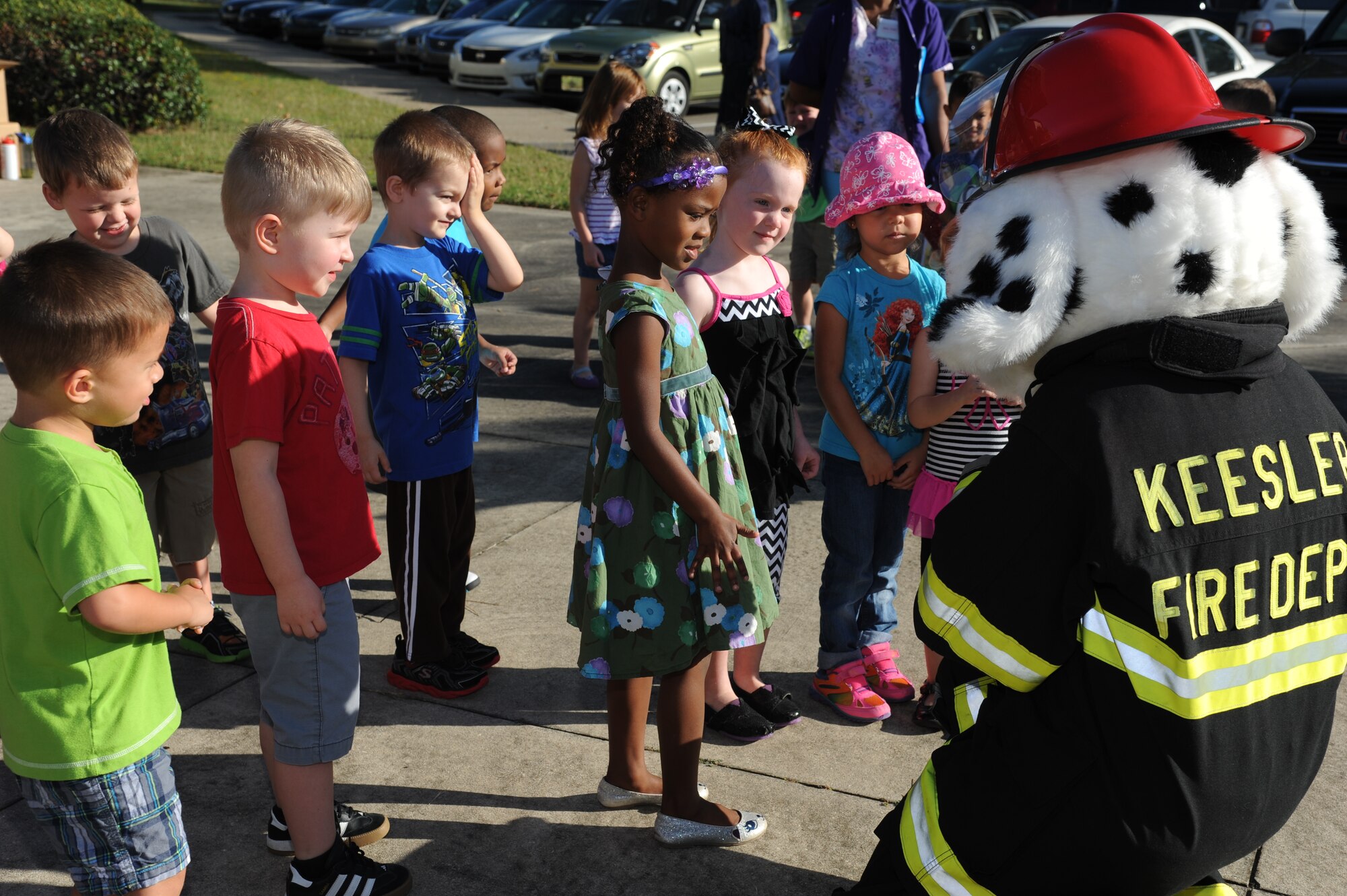 Children at the child development center are welcomed by Sparky the Fire Dog Oct. 7, 2014, during a visit from the Keesler Fire Department for fire prevention week at Keesler Air Force Base, Miss. Throughout fire prevention week the Keesler Fire Department conducted random fire drills, toured various facilities with Sparky the Fire Dog, passed out fire safety handouts and fire hats for children and provided stove and fire extinguisher demonstrations.  The week–long event ended with an open house at the fire station 10 a.m. to 2 p.m. Oct. 11.  (U.S. Air Force photo by Kemberly Groue)