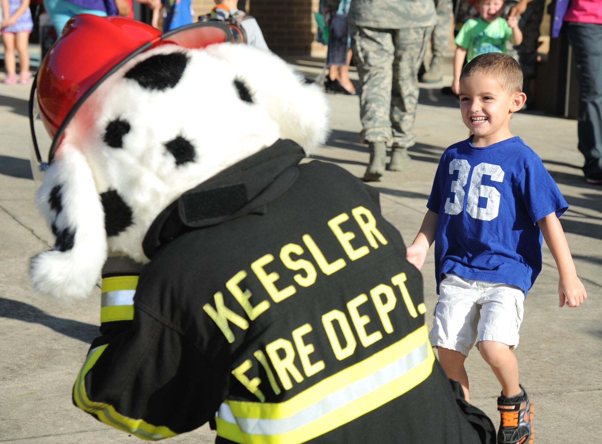 The son of Capt. Benjamin Wright, 335th Training Squadron, runs to give Sparky the Fire Dog a hug Oct. 7, 2014, at the child development center, Keesler Air Force Base, Miss., during a visit from the Keesler Fire Department for fire prevention week. Throughout fire prevention week the Keesler Fire Department conducted random fire drills, toured various facilities with Sparky the Fire Dog, passed out fire safety handouts and fire hats for children and provided stove and fire extinguisher demonstrations.  The week–long event ended with an open house at the fire station 10 a.m. to 2 p.m. Oct. 11.  (U.S. Air Force photo by Kemberly Groue)