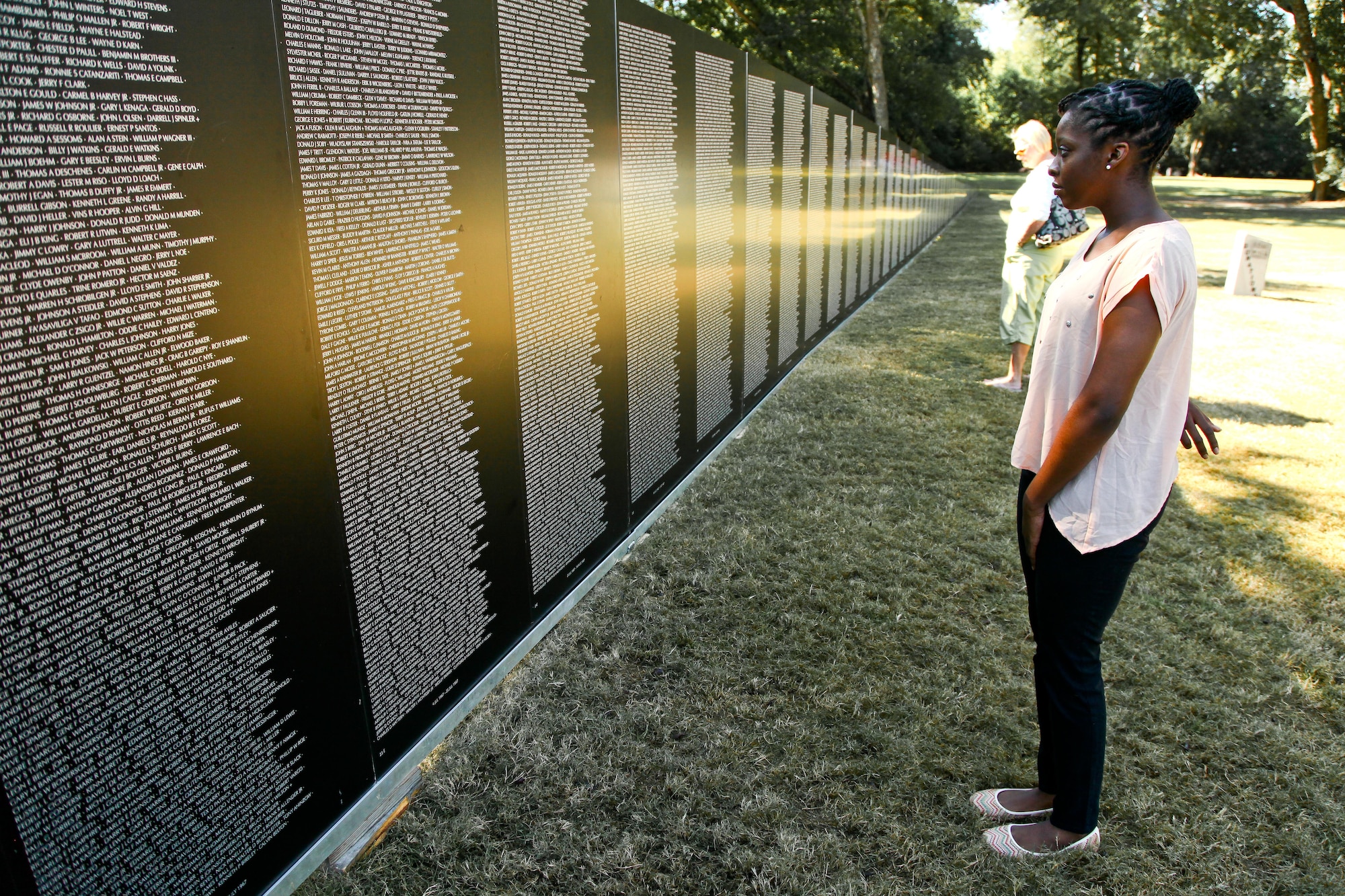 New 315th Airlift Wing member Niyah Sears takes a look at the Vietnam War Memorial wall of fallen service members after her enlistment ceremony Oct. 10, 2014 as she pays her respects at the Vietnam War Memorial at the Patriots Point Naval and Maritime Museum in Mount Pleasant, South Carolina. Sears, a Moncks Corner native, joined six others who also took their oaths of enlistments today at the Memorial. (U.S. Air Force photo by Staff Sgt. Rashard Coaxum)