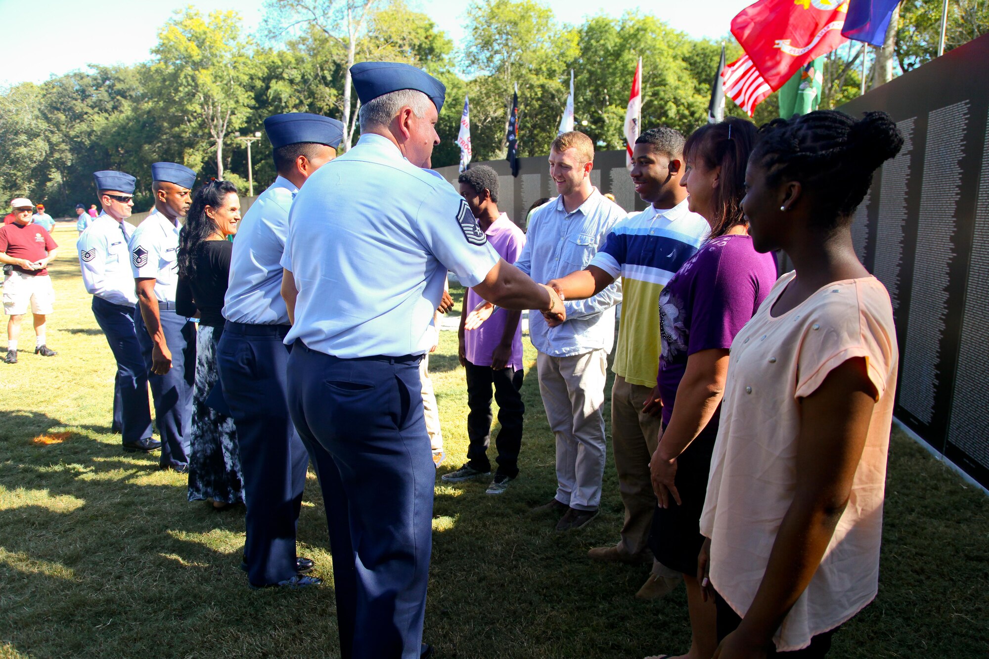 315th Airlift Wing recruiters line up to shake hands with new enlistees after their enlistment ceremony Oct. 10, 2014 in front of the Vietnam War Memorial at the Patriots Point Naval and Maritime Museum in Mount Pleasant, South Carolina. (U.S. Air Force photo by Staff Sgt. Rashard Coaxum)