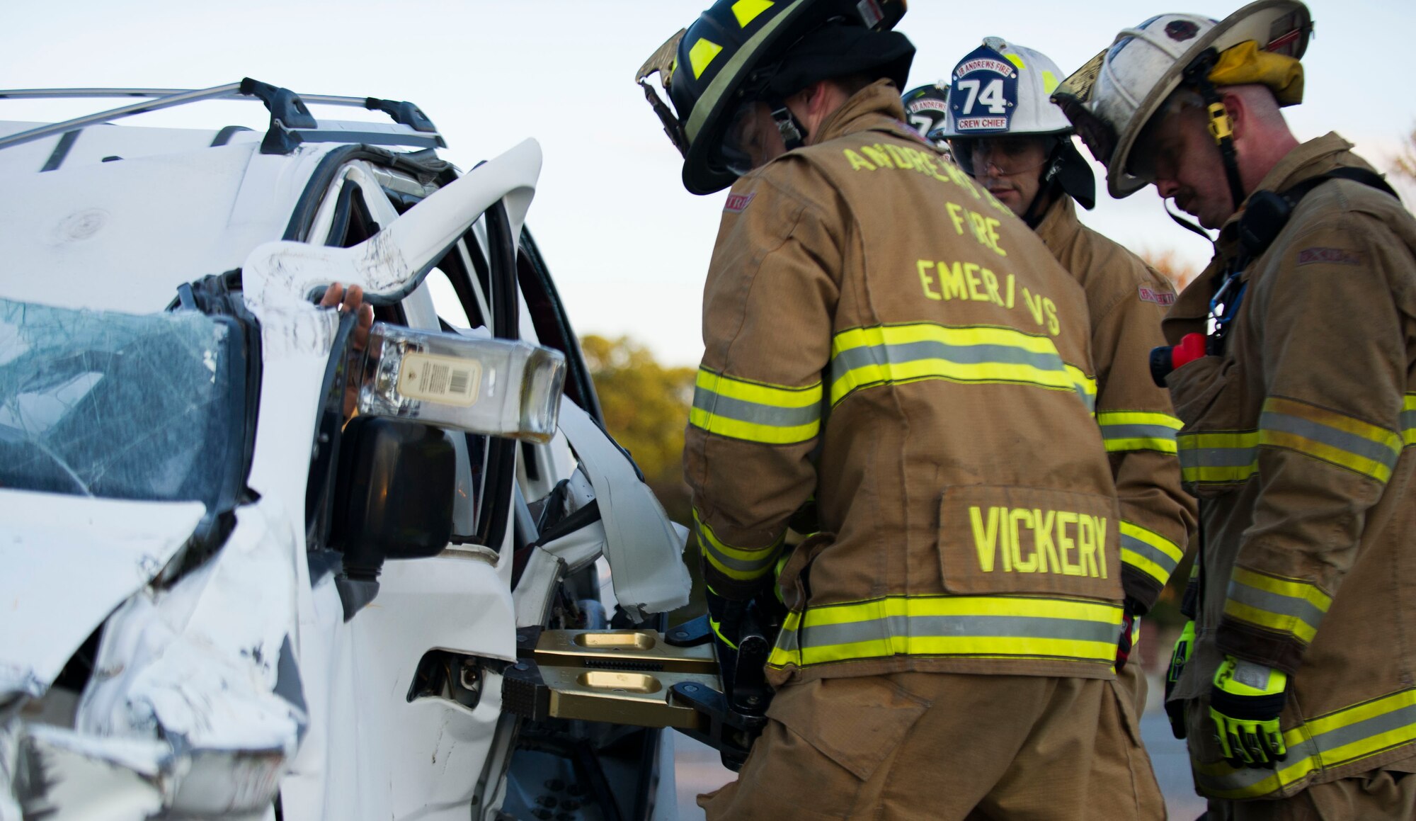 11th Civil Engineer Squadron firefighters demonstrate the procedure for extracting a person from a vehicle during a training exercise on Oct. 8, 2014 at Joint Base Andrews, Md. The exercise was held in the Home Traditions parking lot and open to members of the base populace. The intent was to train and showcase the firefighter’s abilities during Fire Prevention Week. 