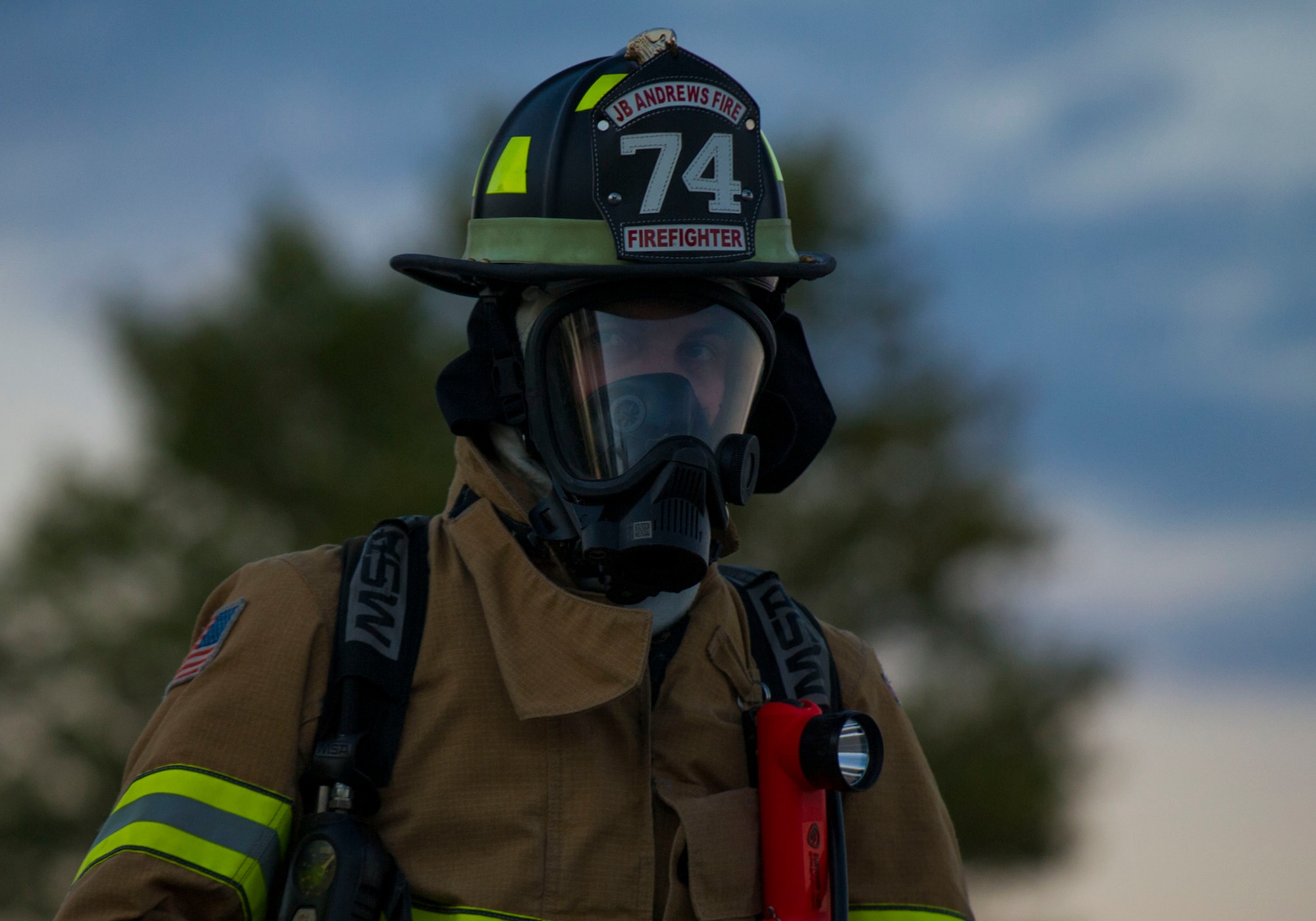 Airman 1st Class Austyn, 11th Civil Engineer Squadron firefighter, looks on as fellow firefighters conduct various training simulations at Joint Base Andrews, Md., Oct 8, 2014. The intent was to train and showcase the firefighter’s abilities during Fire Prevention Week. This year’s theme is “Working Smoke Alarms Save Lives, Test Yours Every Month.” (U.S. Air Force photo/ Senior Airman Mariah Haddenham)