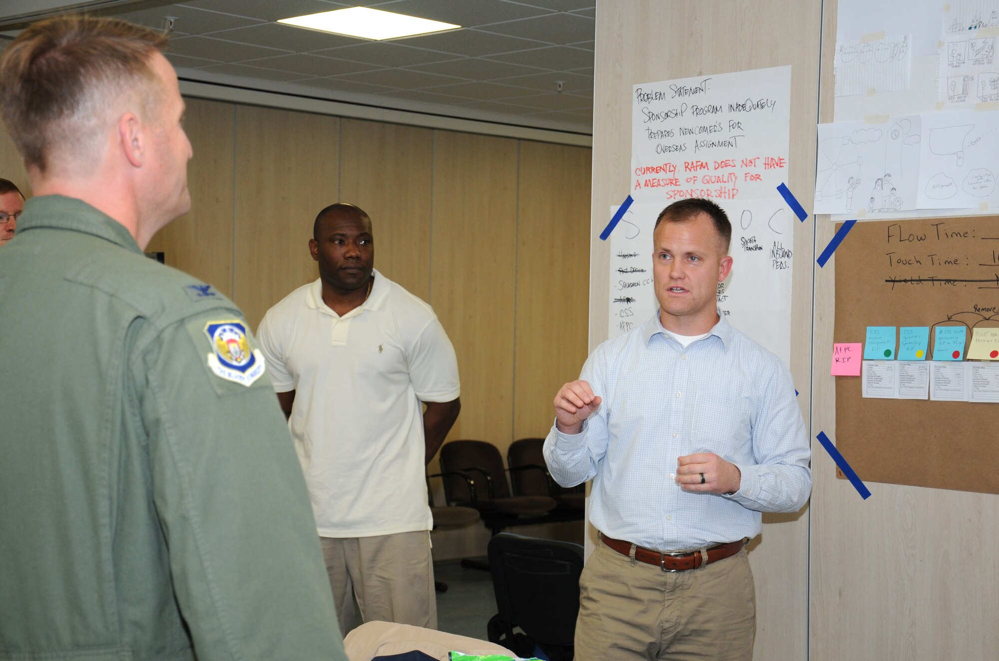 U.S. Air Force Tech. Sgt. Curtis Brown, right, 100th Civil Engineer Squadron Fire Department station chief from Aurora, Colo., briefs U.S. Air Force Col. David Cox, left, 100th Air Refueling Wing vice commander, during an Air Force Smart Operations for the 21st Century class Sept. 26, 2014, on RAF Mildenhall, England. Cox discussed the takeaways of the class where members brainstormed ways to improve the processes that make the mission happen. (U.S. Air Force photo/Gina Randall/Released)