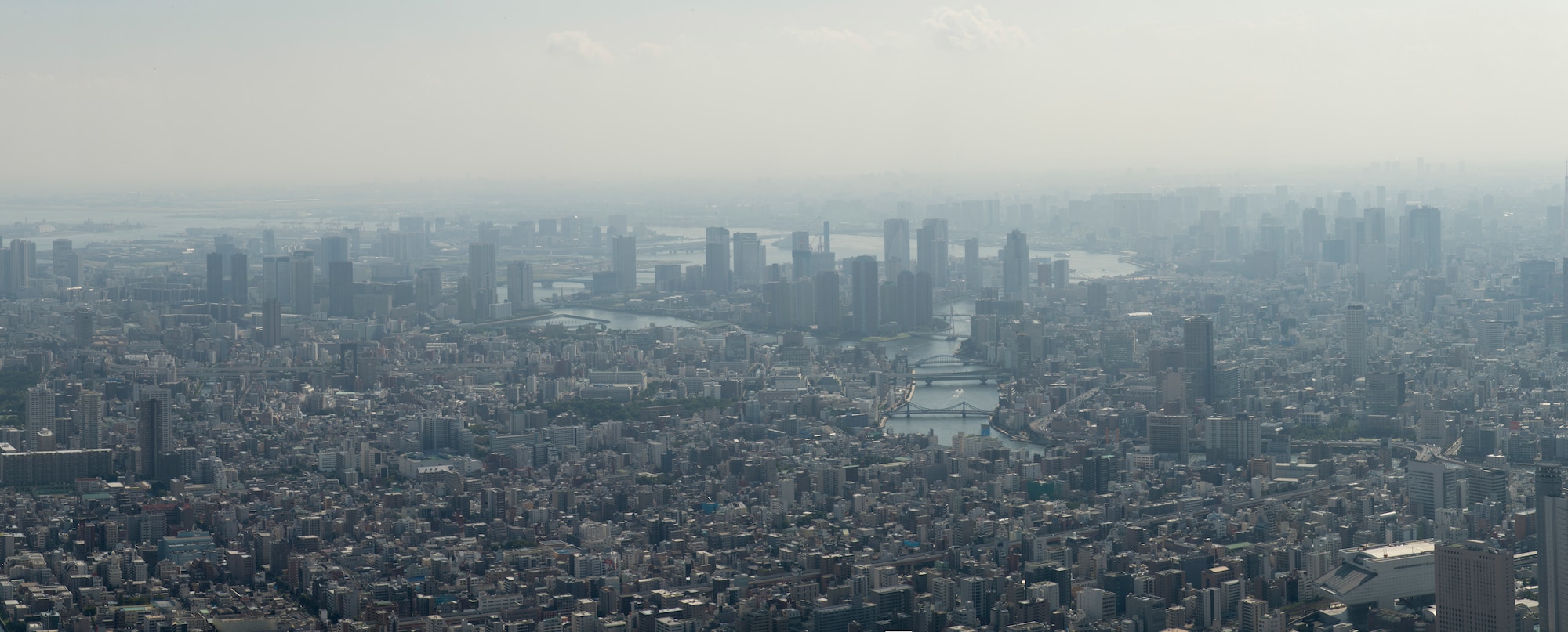 Sumida, Tokyo, Japan, and surrounding cities can be seen in the distance from the top of the Tokyo Skytree, Sept. 12, 2014. The base of the Skytree is a complex of shops, restaurants, offices, a planetarium, aquarium and a postal museum. (U.S. Air Force photo illustration by Senior Airman Michael Washburn/Released)