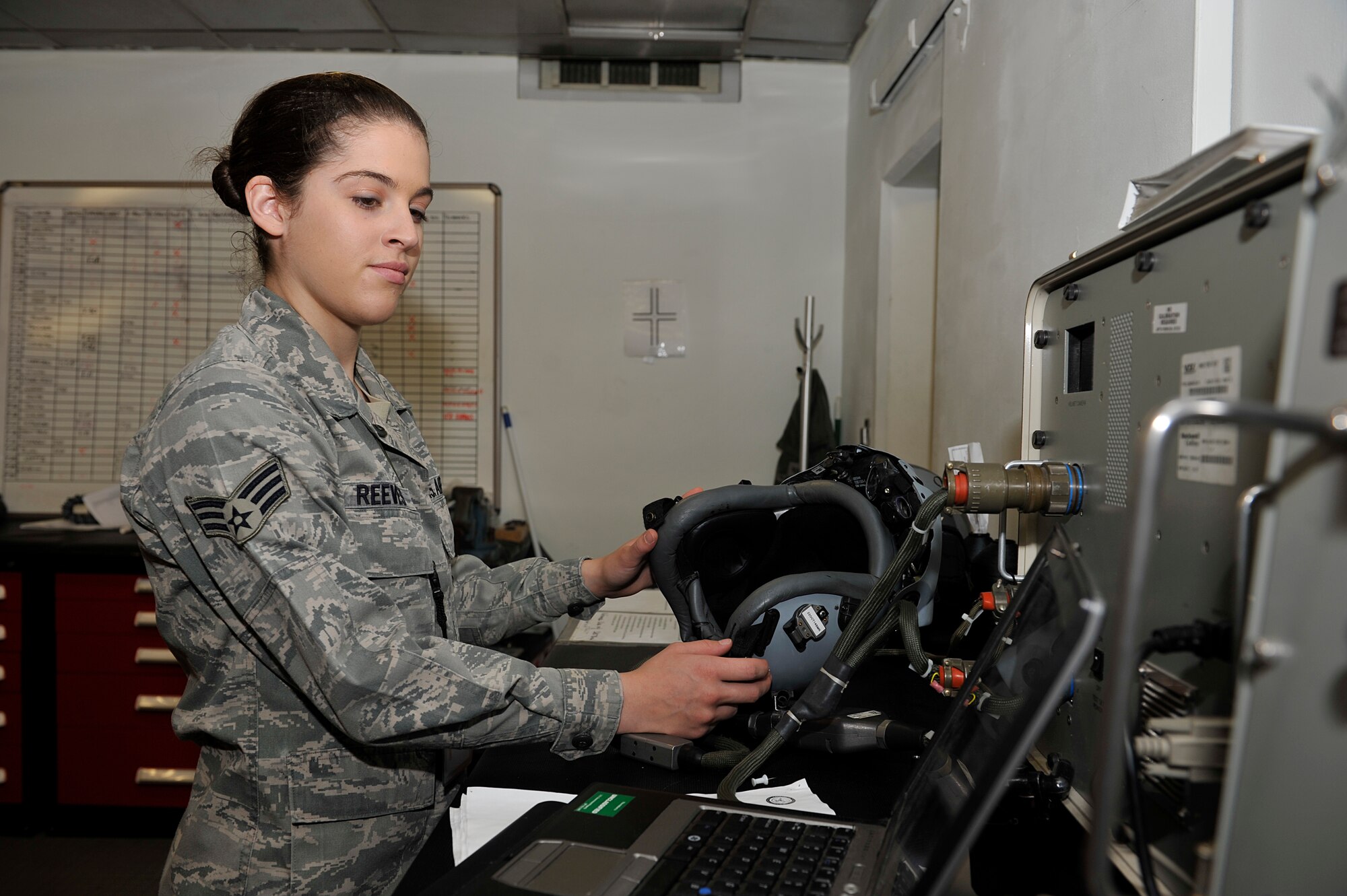 Senior Airman Breanna Reeves, 51st Operations Support Squadron aircrew flight equipment journeyman, checks flight equipment  Oct. 9, 2014, on Osan Air Base, Republic of Korea. Reeves is this week's Airman Spotlight winner. (U.S. Air Force photo by Senior Airman David Owsianka)